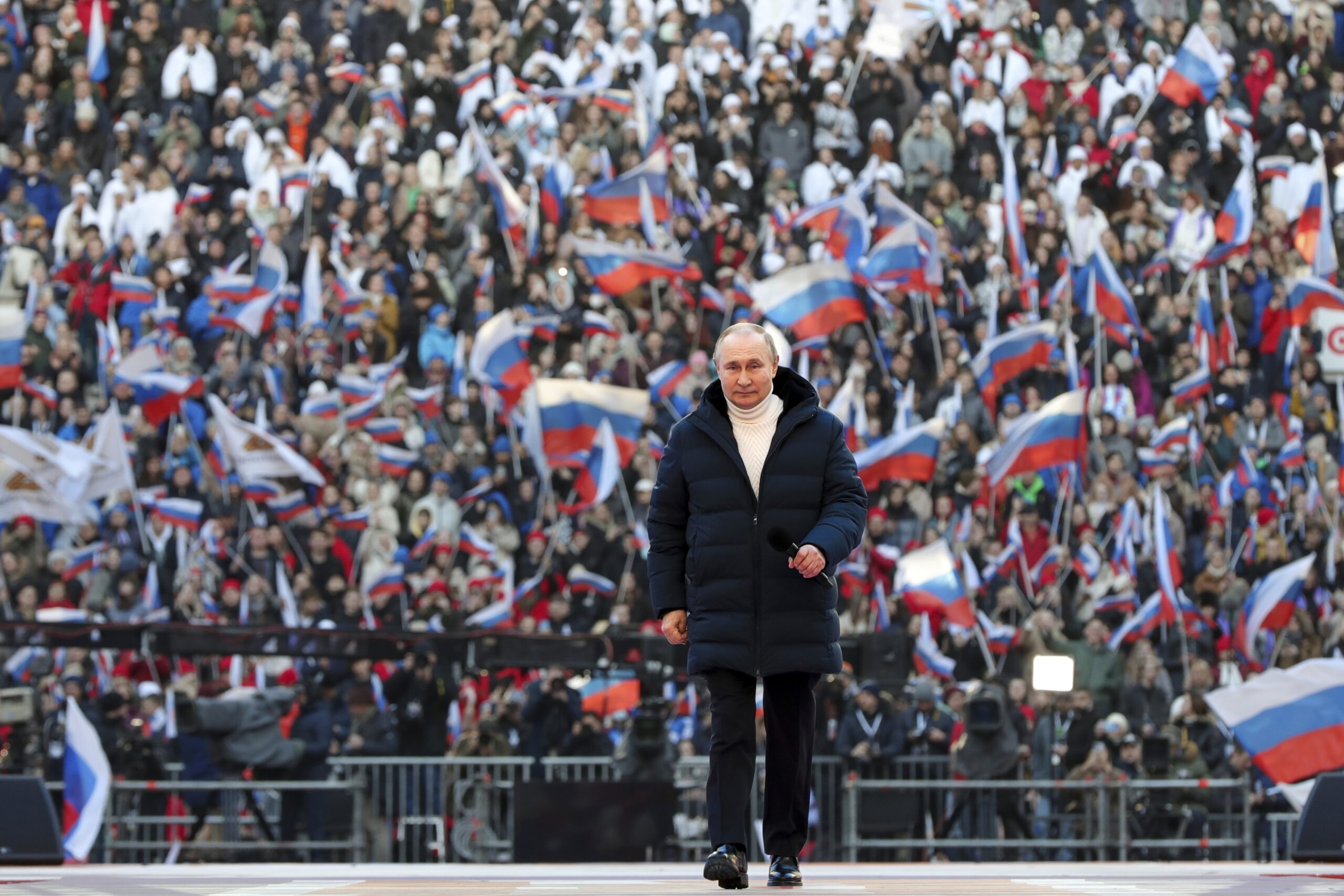 Russian President Vladimir Putin arrives to deliver his speech at the concert marking the eighth anniversary of the referendum on the state status of Crimea and Sevastopol and its reunification with Russia, in Moscow, Russia, Friday, March 18, 2022. (Mikhail Klimentyev, Sputnik, Kremlin Pool Photo via AP)