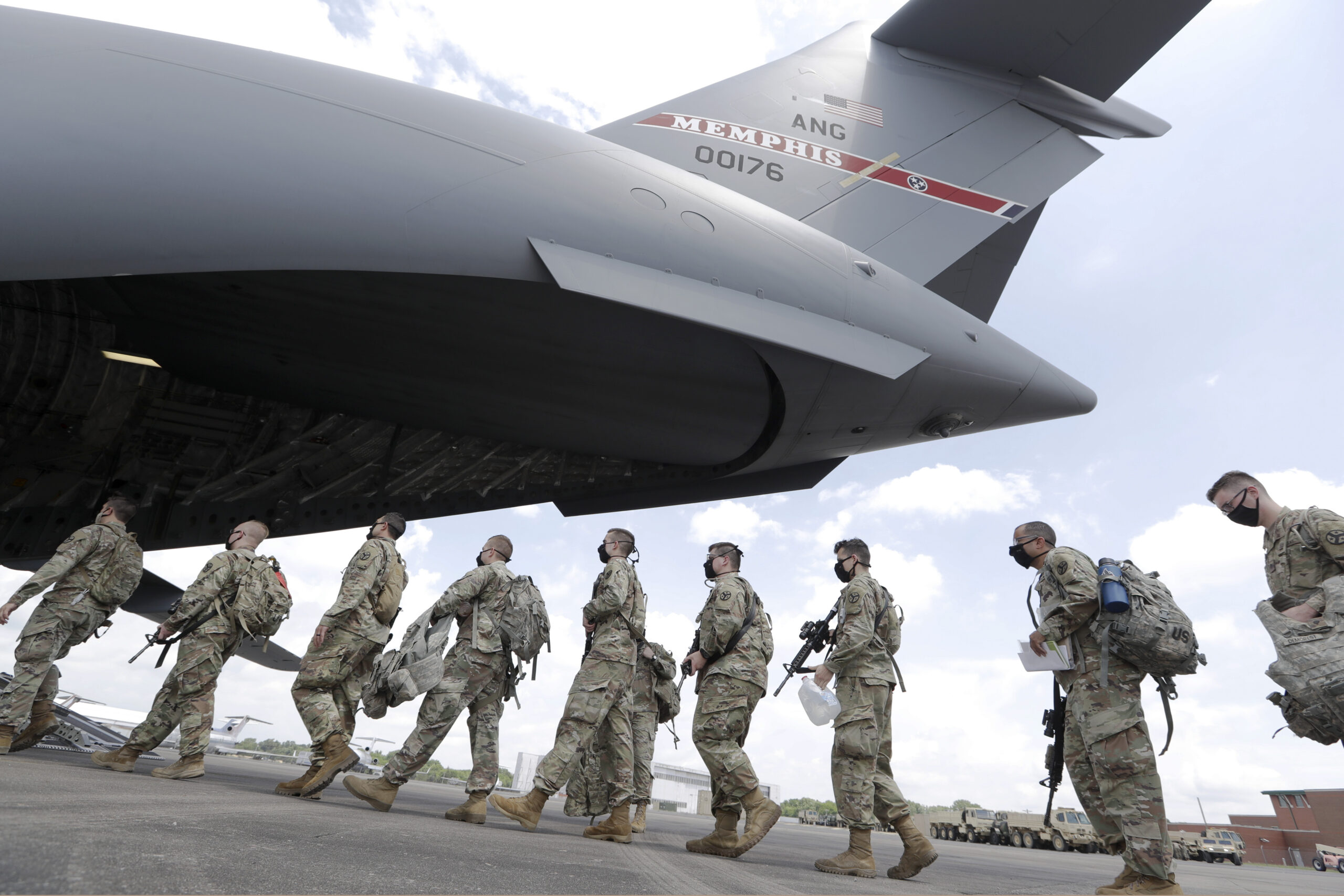 FILE - Tennessee National Guard troops board a plane in Smyrna, Tenn., to go to Washington, Thursday, June 4, 2020. Three current and former members of the Tennessee National Guard are “safe” and “accounted for,” despite a Russian newspaper’s false report, Thursday, March, 17, 2022, that the men were killed while fighting in Ukraine. All three individuals named in the report, are alive and well — and no U.S. military personnel are currently on orders in Ukraine, National Guard Bureau spokesman Wayne Hall said in a phone interview Friday, March 18. (AP Photo/Mark Humphrey, File)