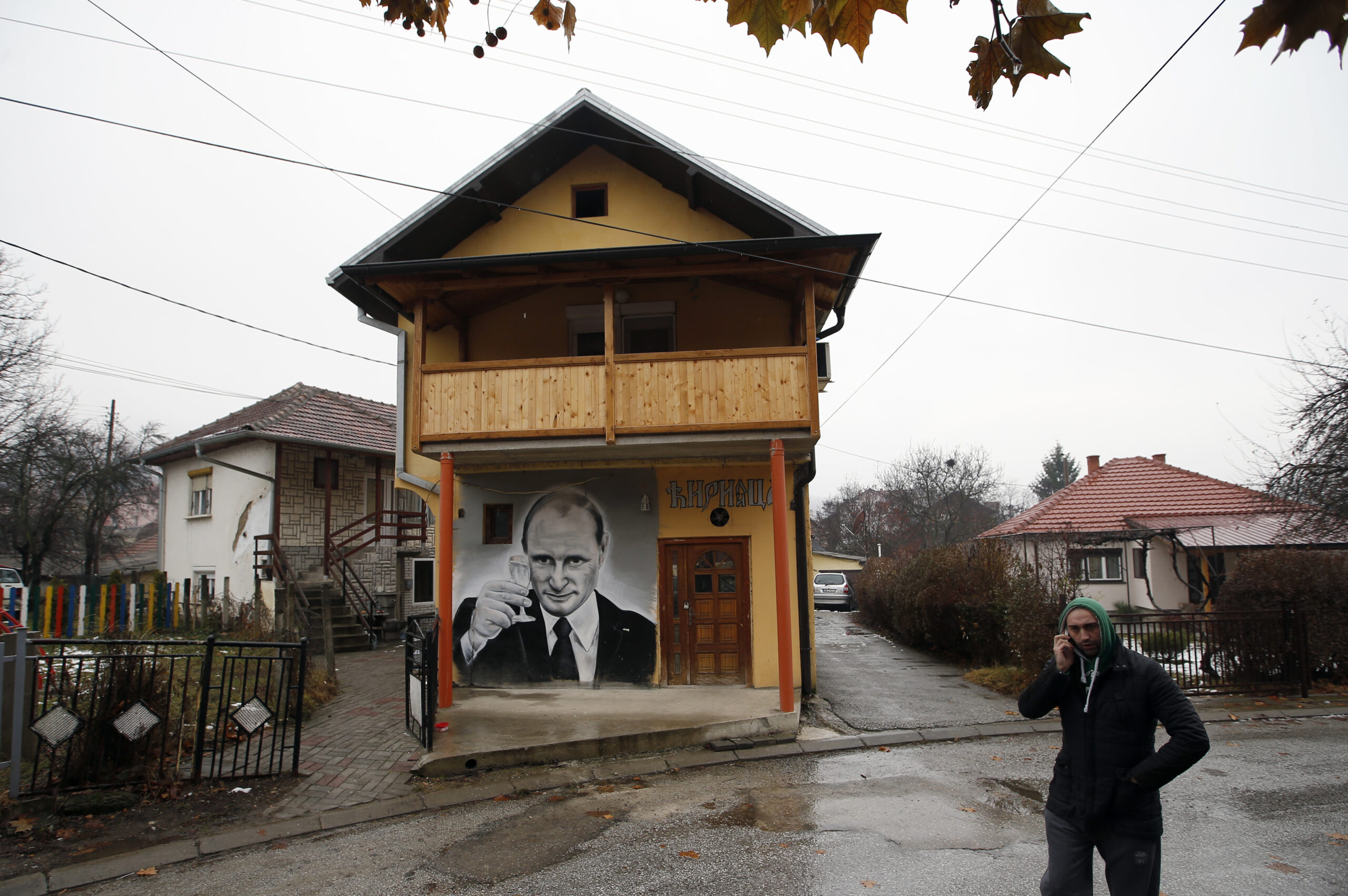 FILE - A man walks past a mural depicting Vladimir Putin, in Zvecan, Kosovo, Dec. 15, 2018. For some European countries watching Russia's bloody invasion of Ukraine, there are fears that they could be next. Western officials say the most vulnerable could be those who are not members of the NATO military alliance or the European Union, and thus alone and unprotected — including Ukraine’s neighbor Moldova and Russia's neighbor Georgia, both of them formerly part of the Soviet Union — along with the Balkan states of Bosnia and Kosovo. (AP Photo/Darko Vojinovic, File)