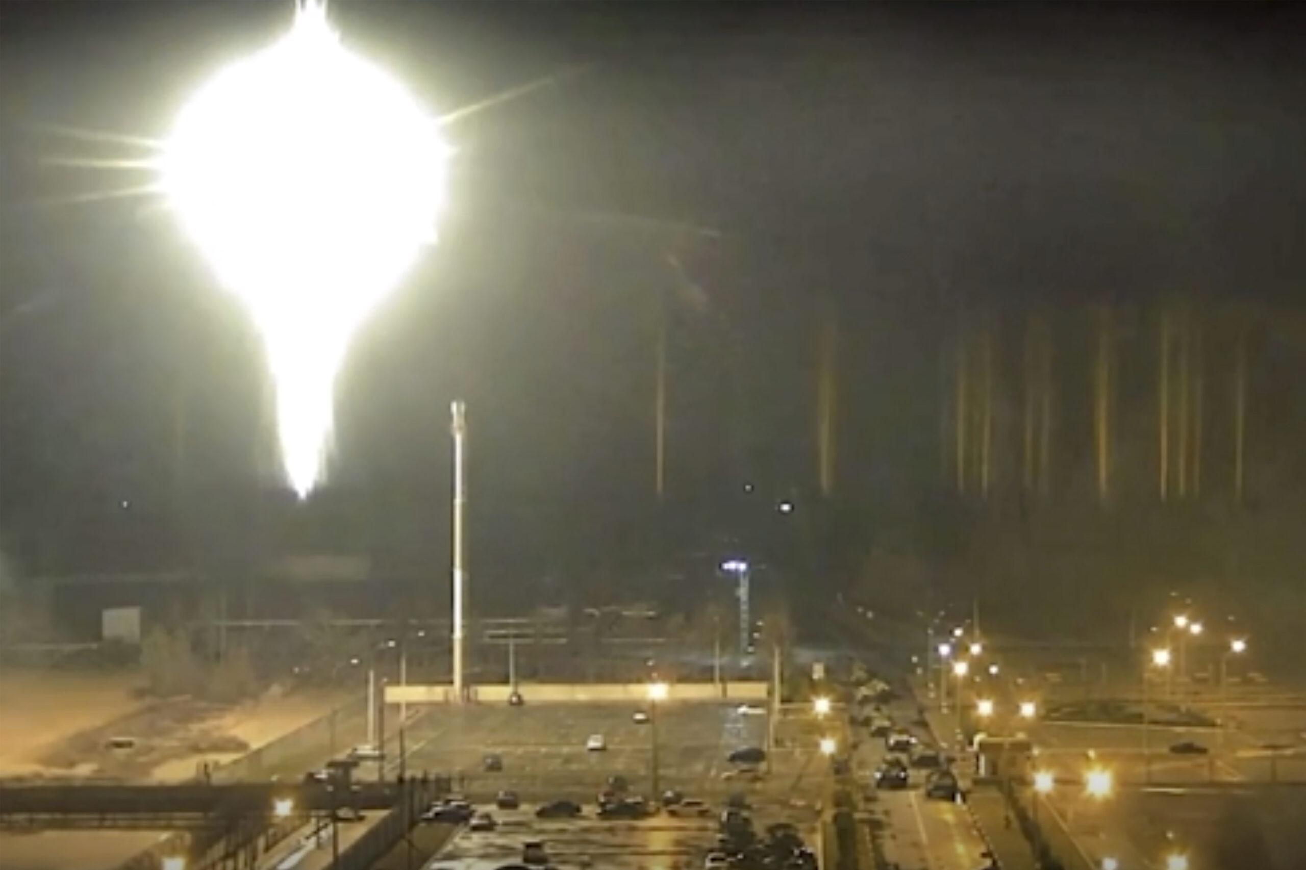 This image made from a video released by Zaporizhzhia nuclear power plant shows bright flaring object landing in grounds of the nuclear plant in Enerhodar, Ukraine Friday, March 4, 2022. Russian forces shelled Europe’s largest nuclear plant early Friday, sparking a fire as they pressed their attack on a crucial energy-producing Ukrainian city and gained ground in their bid to cut off the country from the sea. (Zaporizhzhia nuclear power plant via AP)