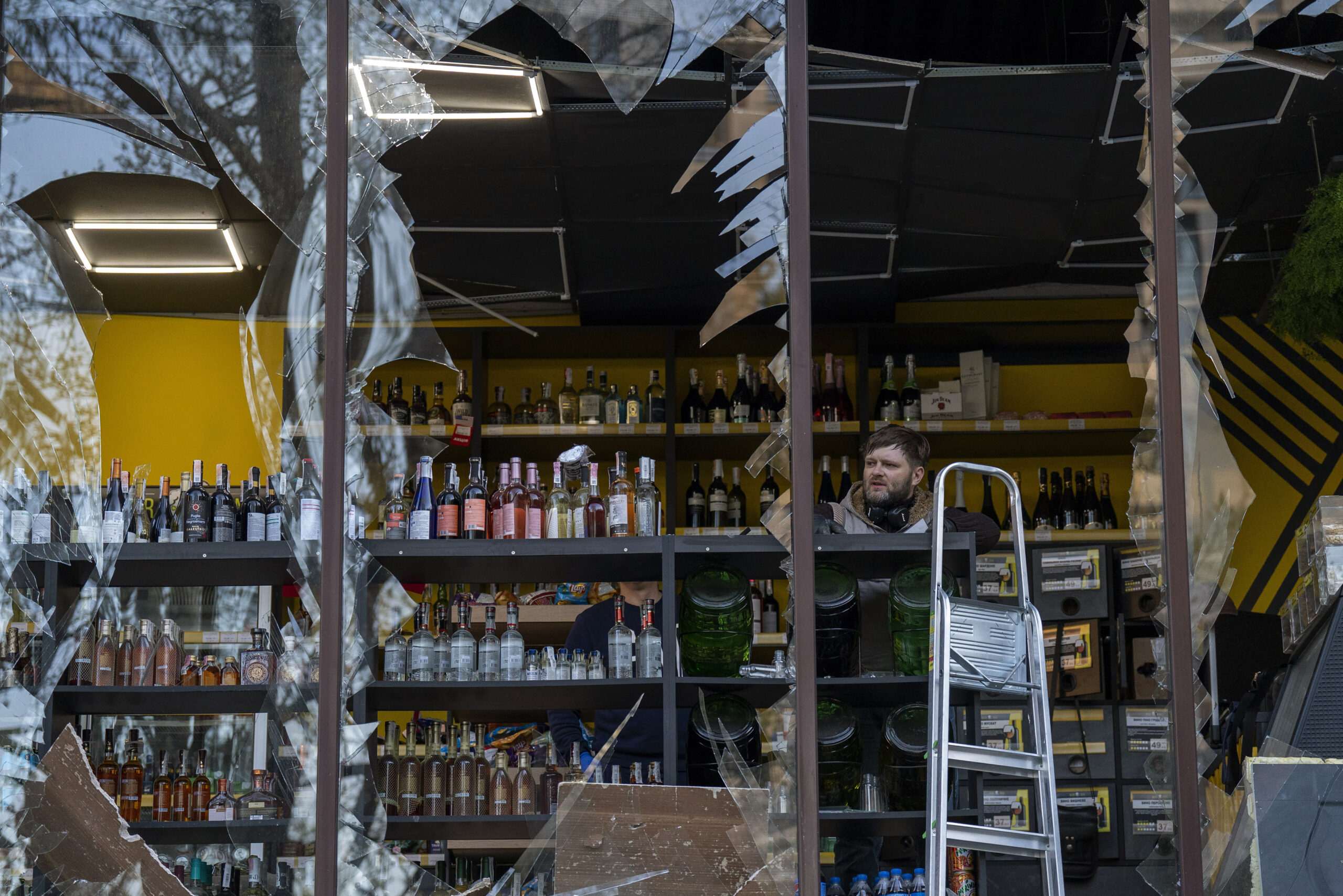 A liquor store owner looks at the damage to his shop caused by an explosion in Kyiv, Ukraine on Friday, April 29, 2022. Russia struck the Ukrainian capital of Kyiv shortly after a meeting between President Volodymyr Zelenskyy and U.N. Secretary-General António Guterres on Thursday evening. (AP Photo/Emilio Morenatti)