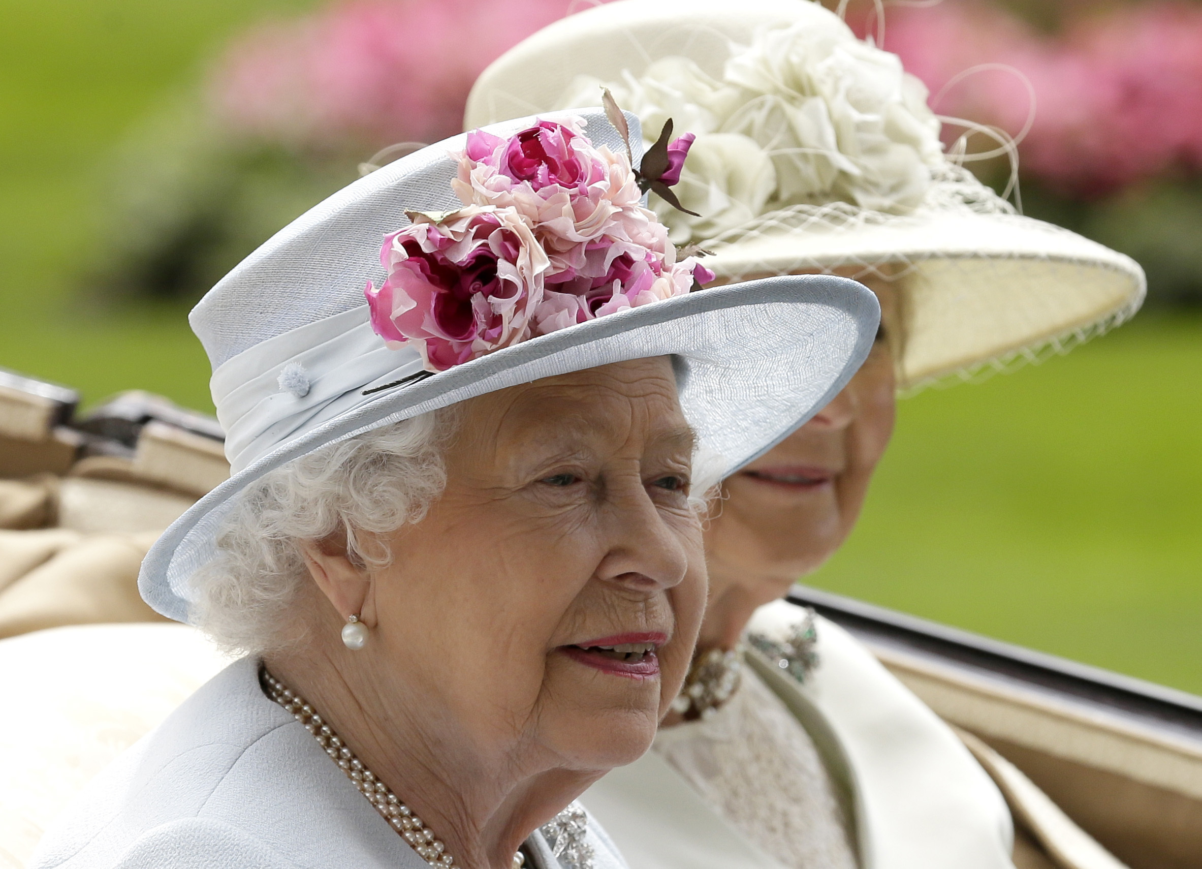 FILE - Britain's Queen Elizabeth II arrives at the parade ring with Princess Alexandra in a horse drawn carriage, on the second day of the Royal Ascot horse race meeting in Ascot, England, Wednesday, June 20, 2018. Queen Elizabeth II is marking her 96th birthday privately on Thursday, April 21, 2022 retreating to the Sandringham estate in eastern England that has offered the monarch and her late husband, Prince Philip, a refuge from the affairs of state. (AP Photo/Tim Ireland, File)