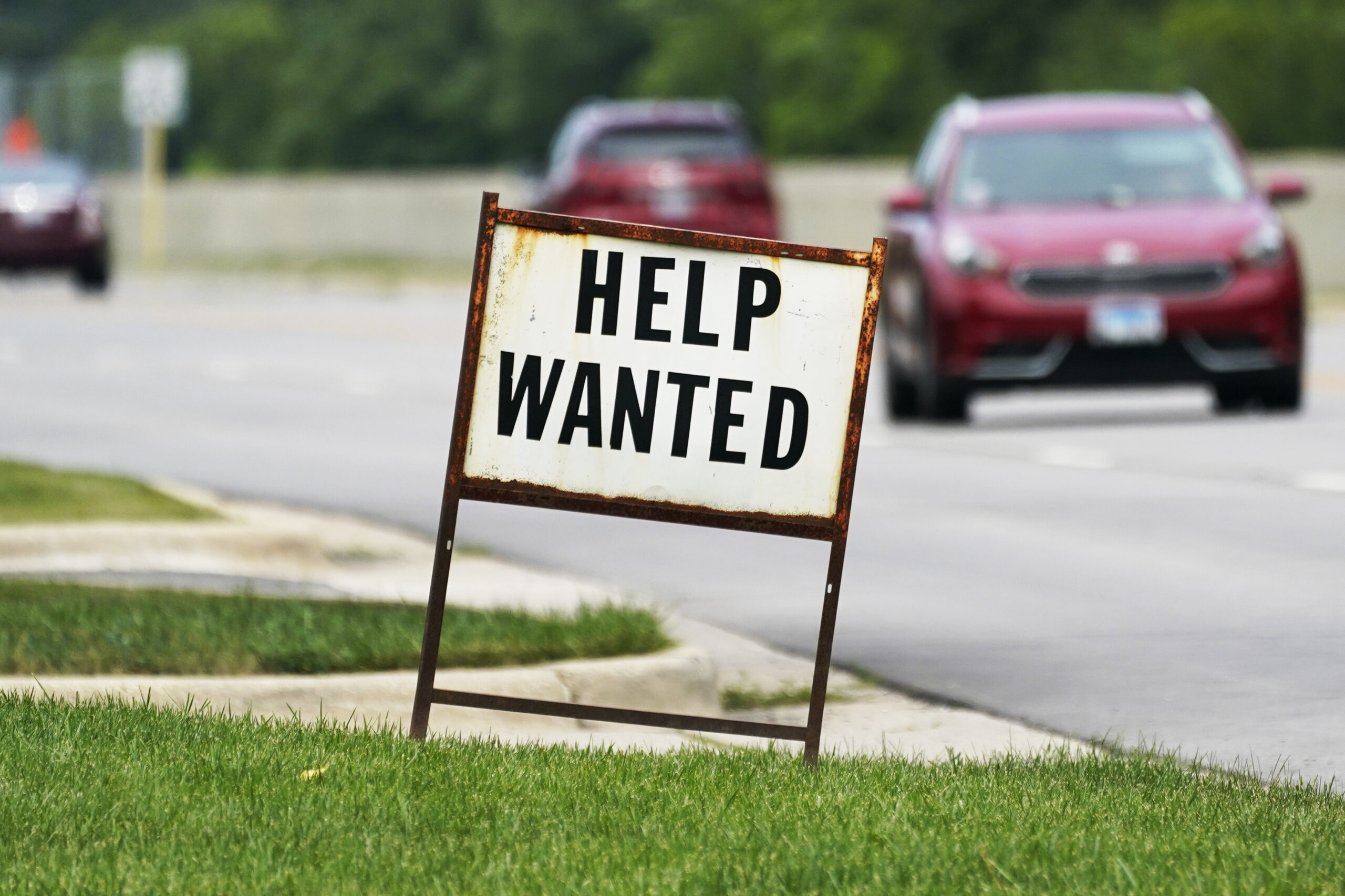 FILE - A help wanted sign is displayed at a gas station in Mount Prospect, Ill., Tuesday, July 27, 2021. Fewer Americans applied for unemployment benefits last week as layoffs remain at historically low levels. Jobless claims fell by 5,000 to 166,000 for the week ending April 2, 2022 the Labor Department reported Thursday. (AP Photo/Nam Y. Huh)