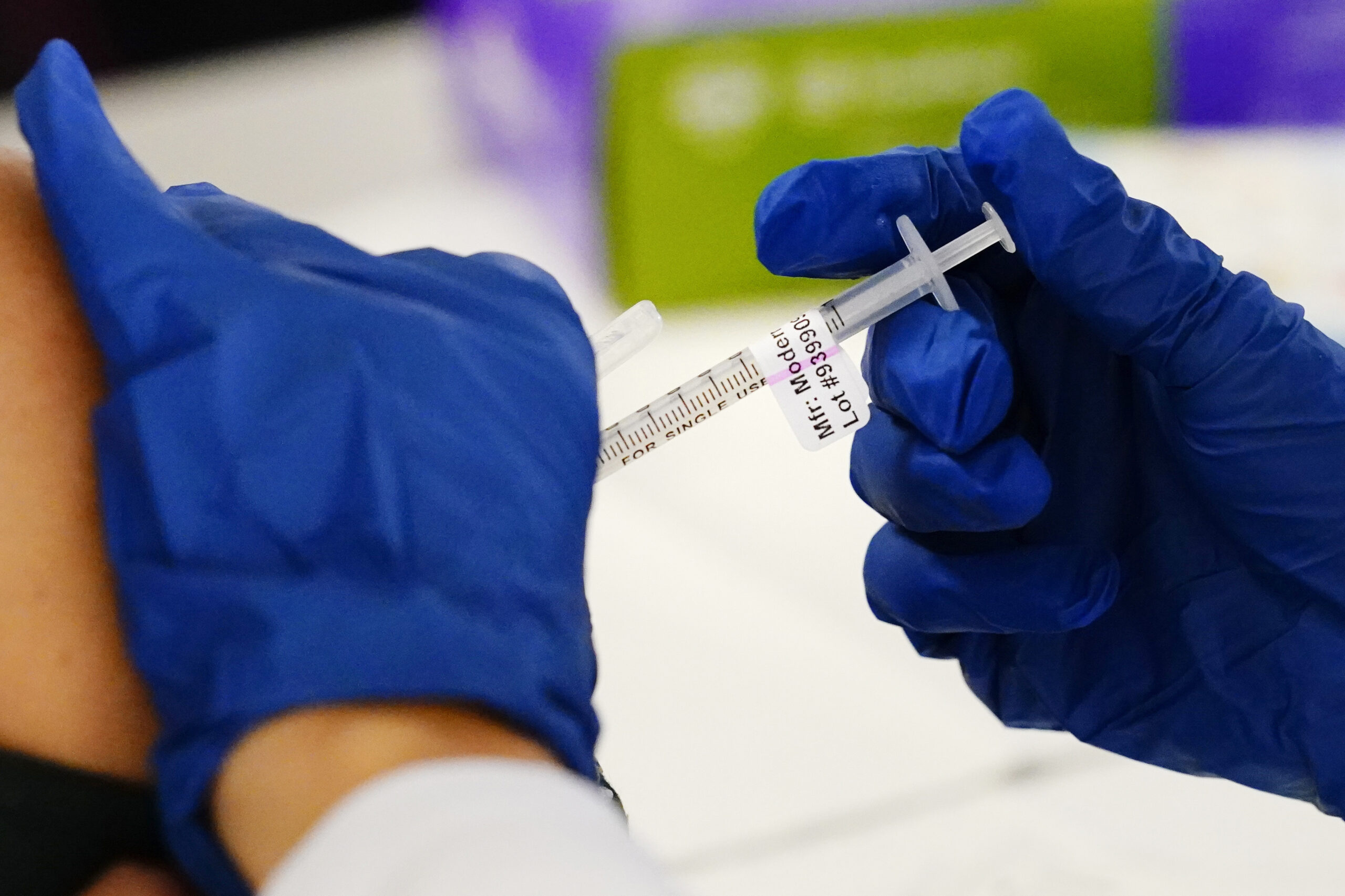 FILE - A health worker administers a dose of a Moderna COVID-19 vaccine during a vaccination clinic in Norristown, Pa., Tuesday, Dec. 7, 2021. Moderna on Thursday, April 28, 2022, asked U.S. regulators to authorize low doses of its COVID-19 vaccine for children younger than 6, a long-awaited move toward potentially opening shots for millions of tots by summer.(AP Photo/Matt Rourke, File)
