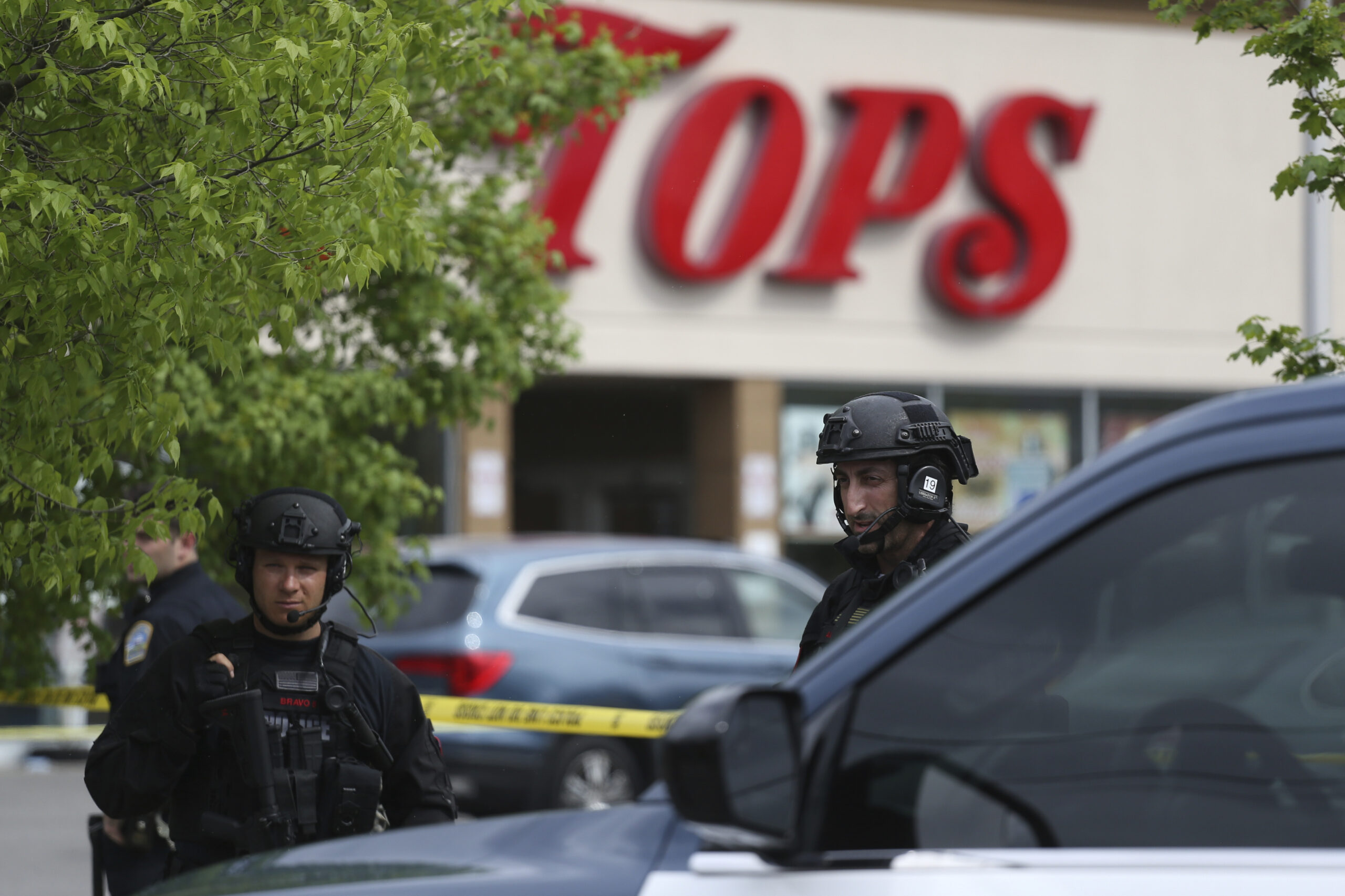 Police secure a perimeter after a shooting at a supermarket, Saturday, May 14, 2022, in Buffalo, N.Y. (AP Photo/Joshua Bessex)