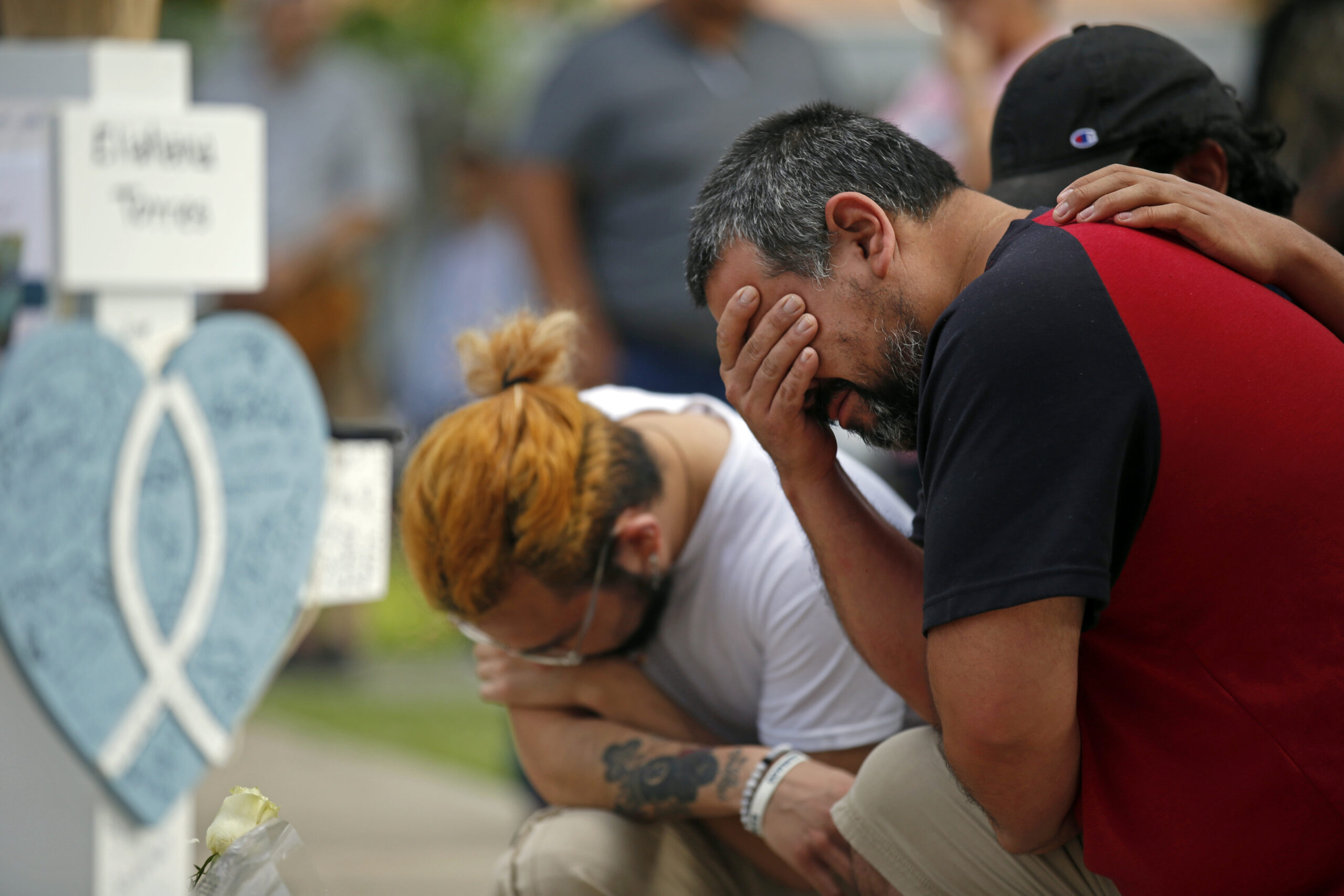 Vincent Salazar, right, father of Layla Salazar, weeps while kneeling in front of a cross with his daughter's name at a memorial site for the victims killed in this week's elementary school shooting in Uvalde, Texas, Friday, May 27, 2022. (AP Photo/Dario Lopez-Mills)