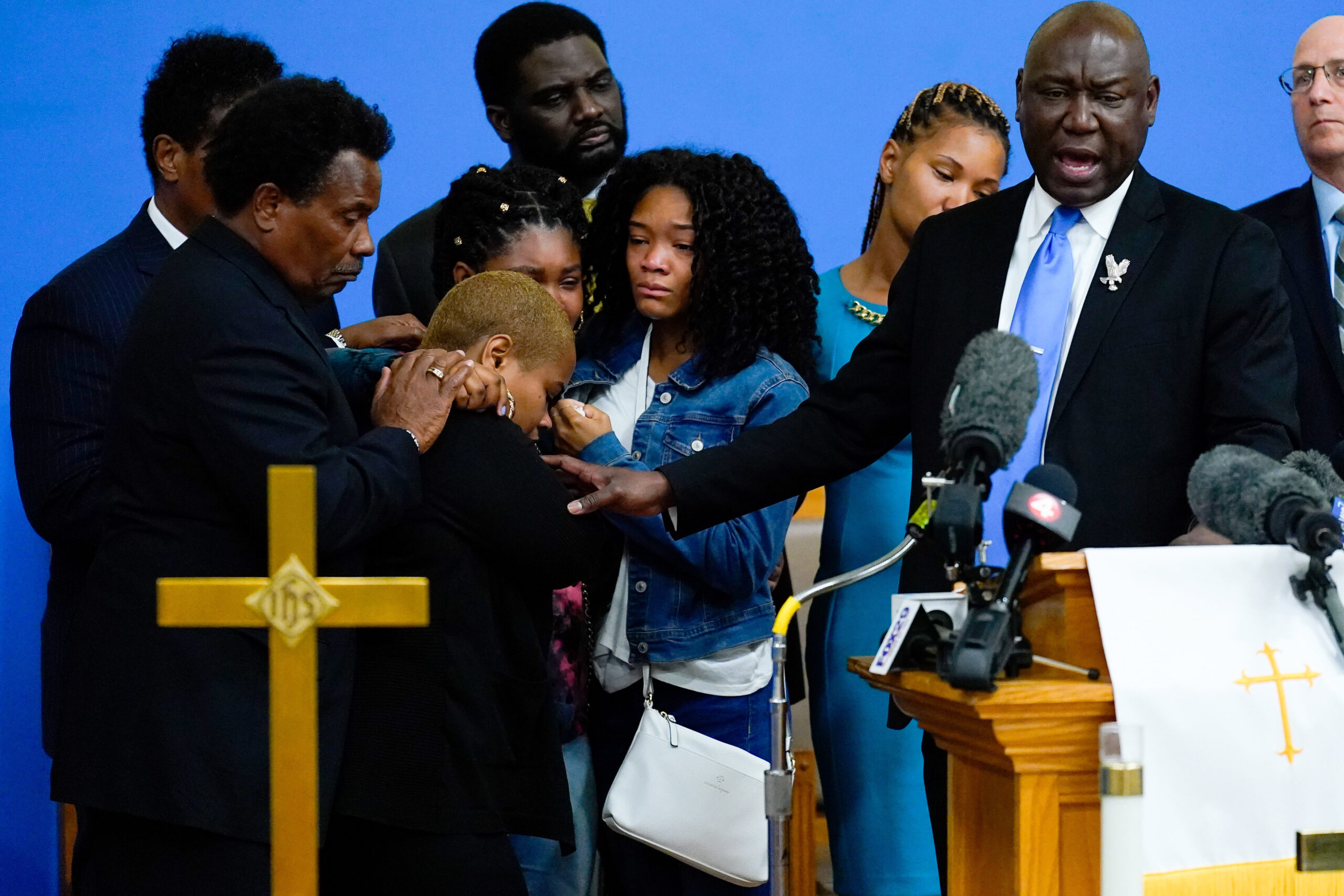 Attorney Benjamin Crump, right, accompanied by the family of Ruth Whitfield, a victim of shooting at a supermarket, speaks with members of the media during a news conference in Buffalo, N.Y., Monday, May 16, 2022. (AP Photo/Matt Rourke)