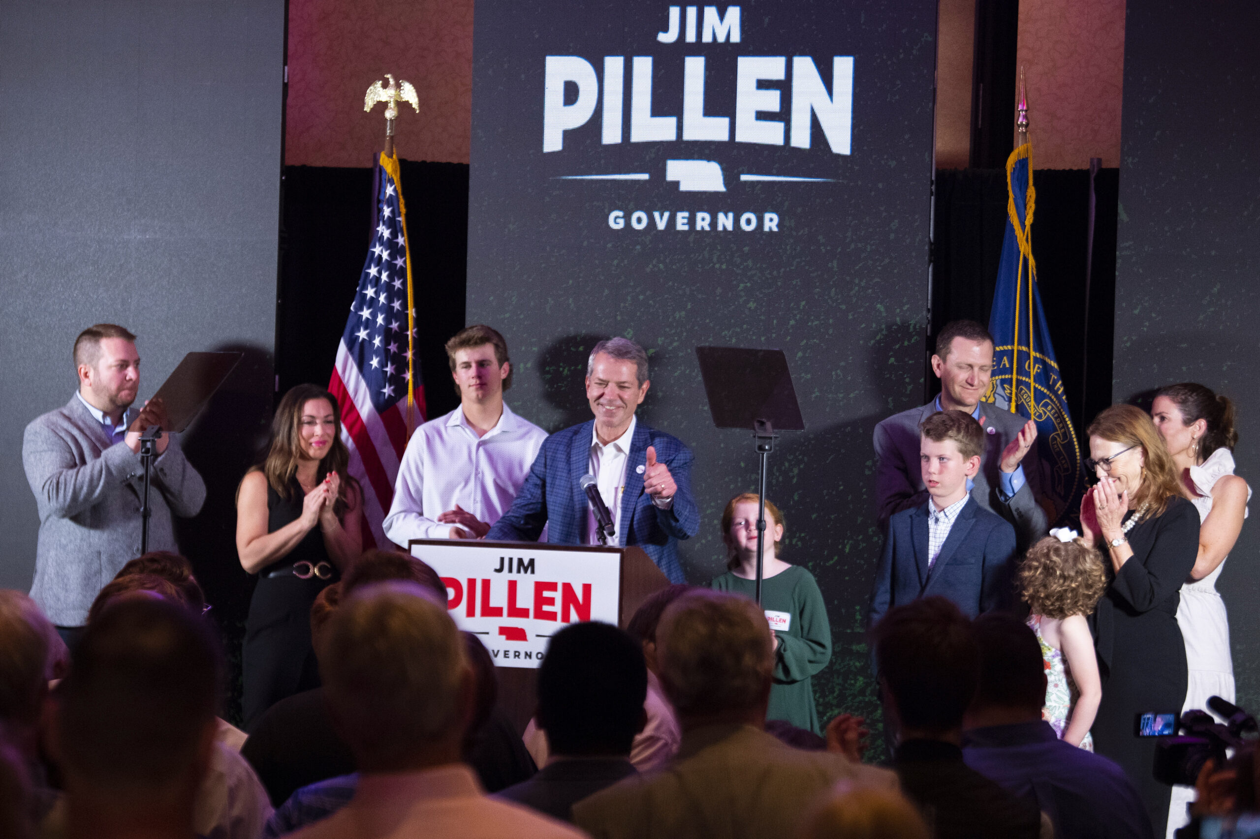 University of Nebraska Regent Jim Pillen, center, gives a thumbs up to a wave of applause as he is named the winner of the Nebraska Republican gubernatorial primary during an election night party at the Embassy Suites on Tuesday, May 10, 2022, in Lincoln, Neb. (Kenneth Ferriera/Lincoln Journal Star via AP)