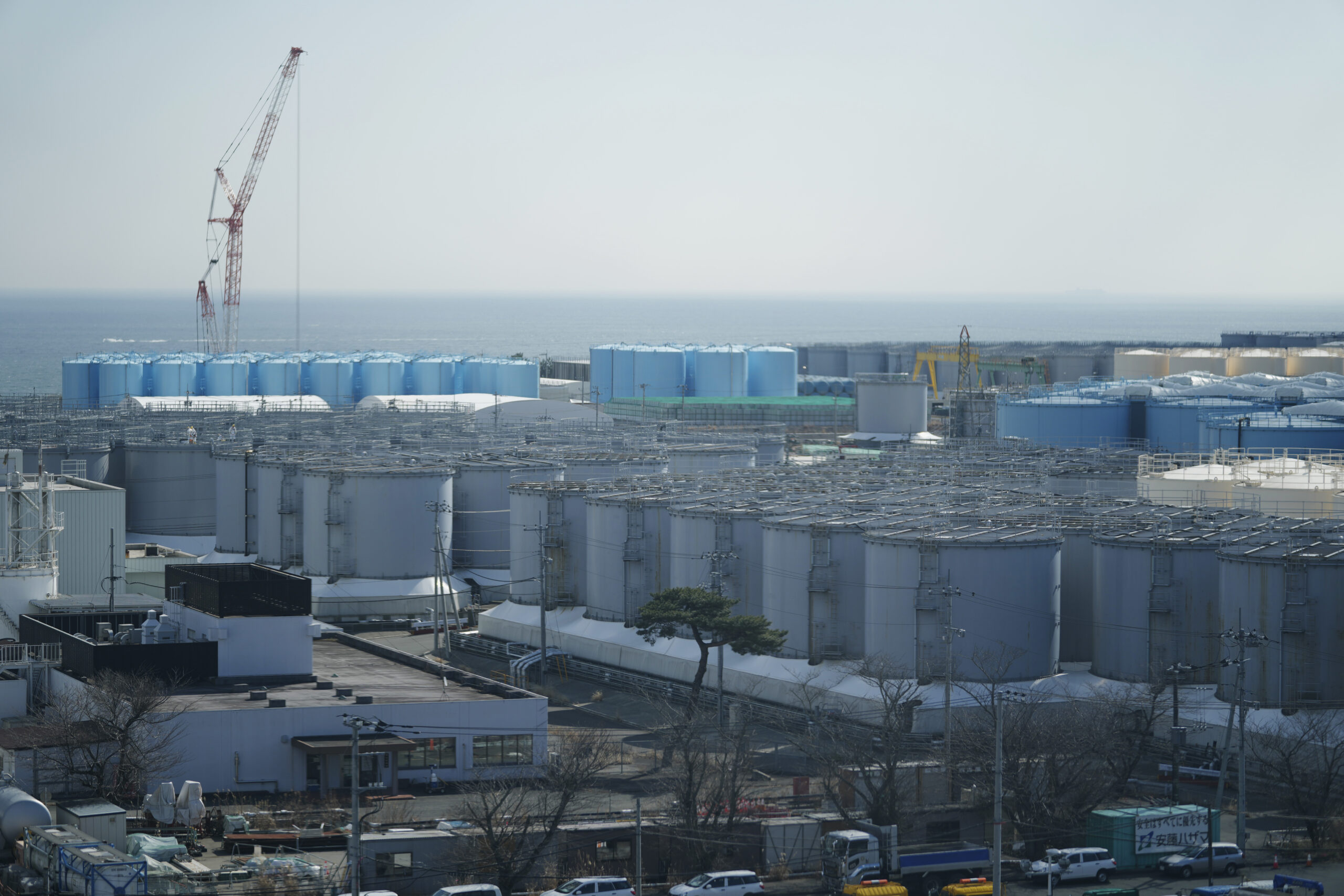 FILE - Tanks storing treated radioactive water after it was used to cool the melted fuel are seen at the Fukushima Daiichi nuclear power plant, run by Tokyo Electric Power Company Holdings (TEPCO), in Okuma town, northeastern Japan, on March 3, 2022. Japan’s nuclear regulator on Wednesday, May 18, 2022, approved plans by the operator of the wrecked Fukushima nuclear plant to release its treated radioactive wastewater into the sea next year, saying the outlined methods are safe and risks to the environment minimal. (AP Photo/Hiro Komae, File)