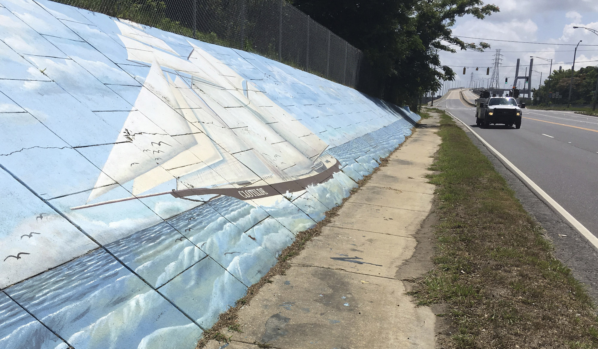 FILE - Traffic passes a mural of the slave ship Clotilda along Africatown Boulevard, in Mobile, Ala., May 30, 2019. Researchers are returning to the Alabama coast near Mobile in May 2022 to assess the sunken remains of the Clotilda, which was the last slave ship to bring captive Africans to the United States more than 160 years earlier. (AP Photo/Kevin McGill, File)