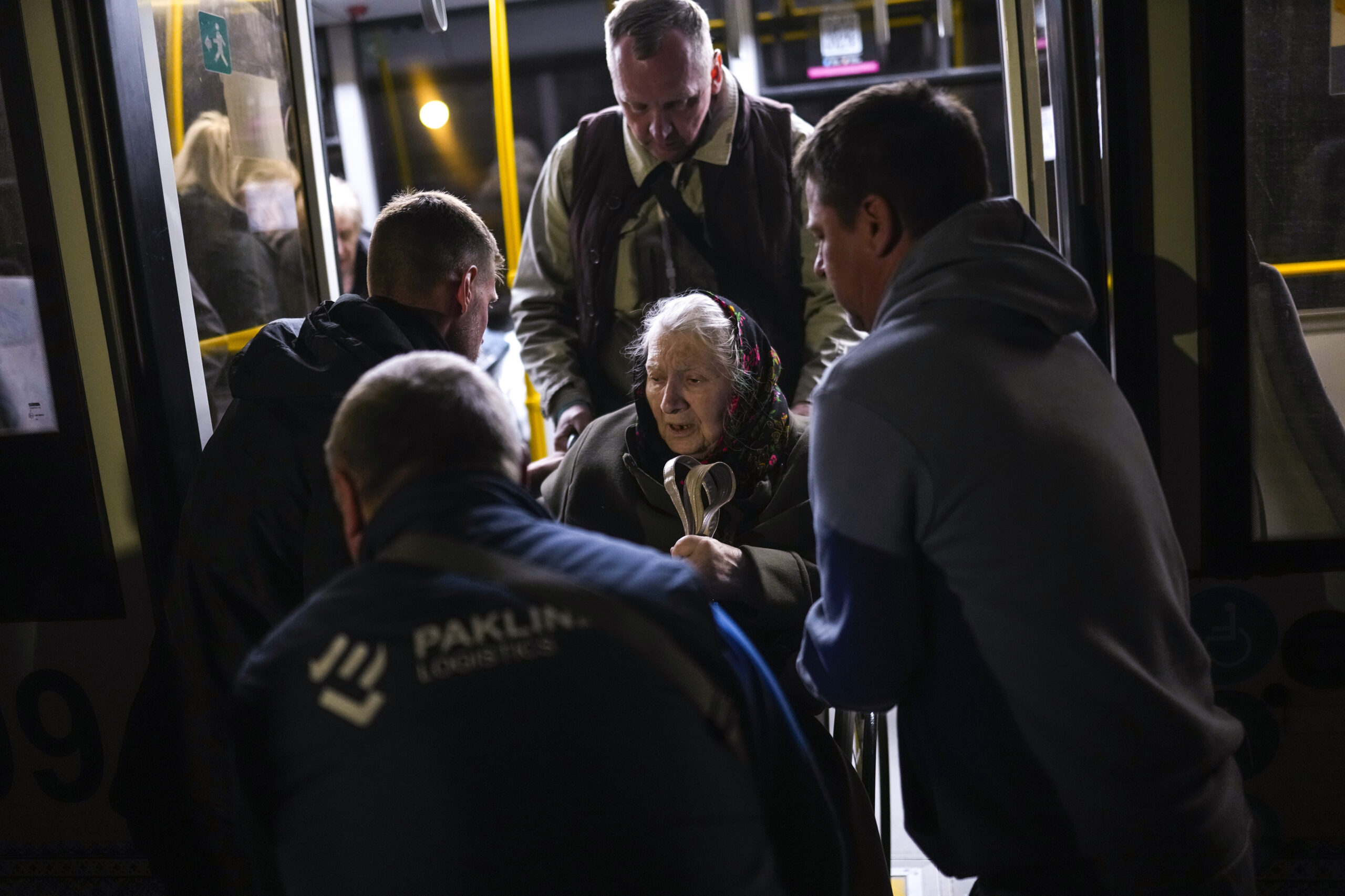 A woman who fled from the Azovstal steel plant in Mariupol is helped from a bus upon her arrival at a reception center for displaced people in Zaporizhzhia, Ukraine, late Sunday, May 8, 2022. Thousands of Ukrainians continue to leave Russian-occupied areas. (AP Photo/Francisco Seco)