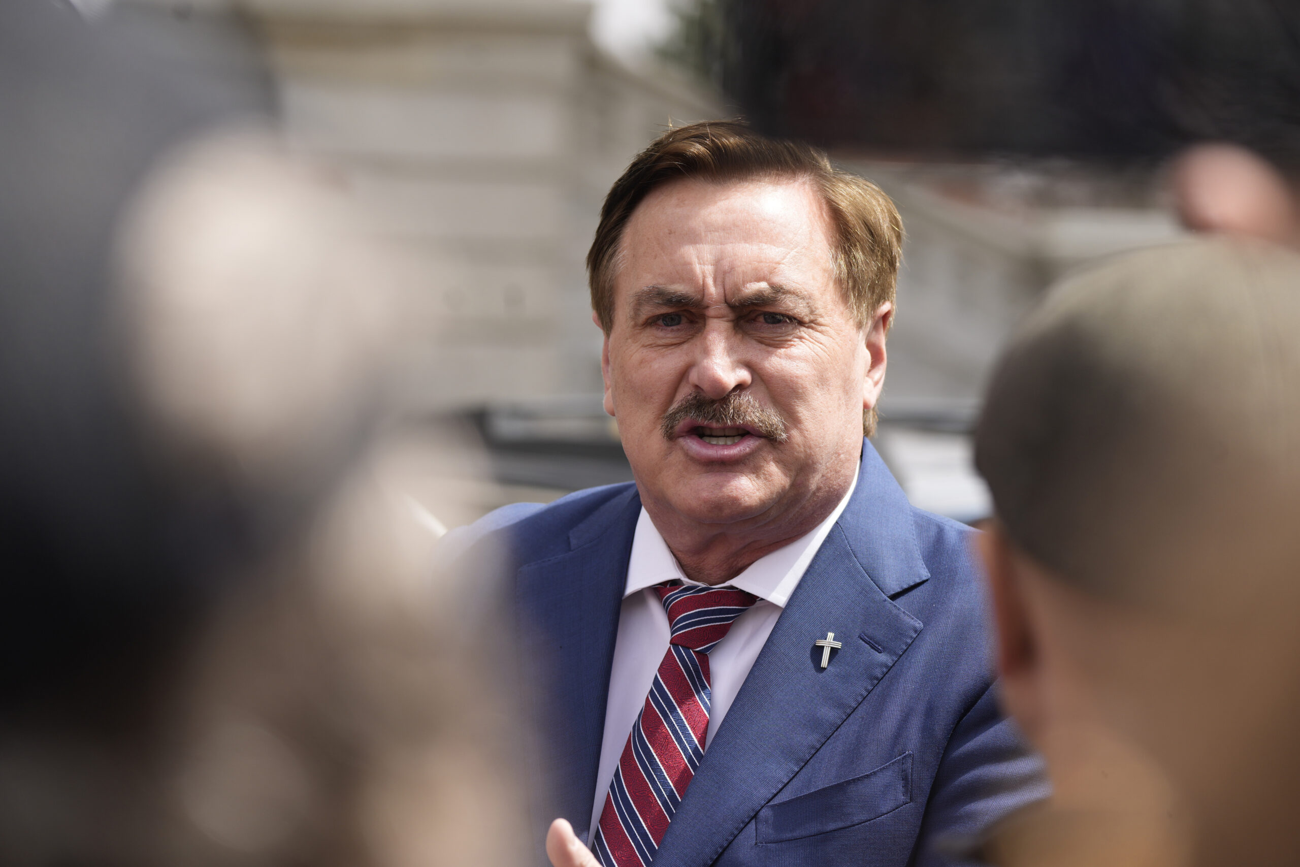 Mike Lindell, chief executive officer of MyPillow, talks to reporters before attending a rally outside the State Capitol, April 5, 2022, in downtown Denver. Lindell was banned from Twitter for a second time after attempting to use a new account to access the social media platform. Lindell set up a new account on Twitter on Sunday, May 1, 2022 under @MikeJLindell. But the account was quickly suspended. (AP Photo/David Zalubowski)