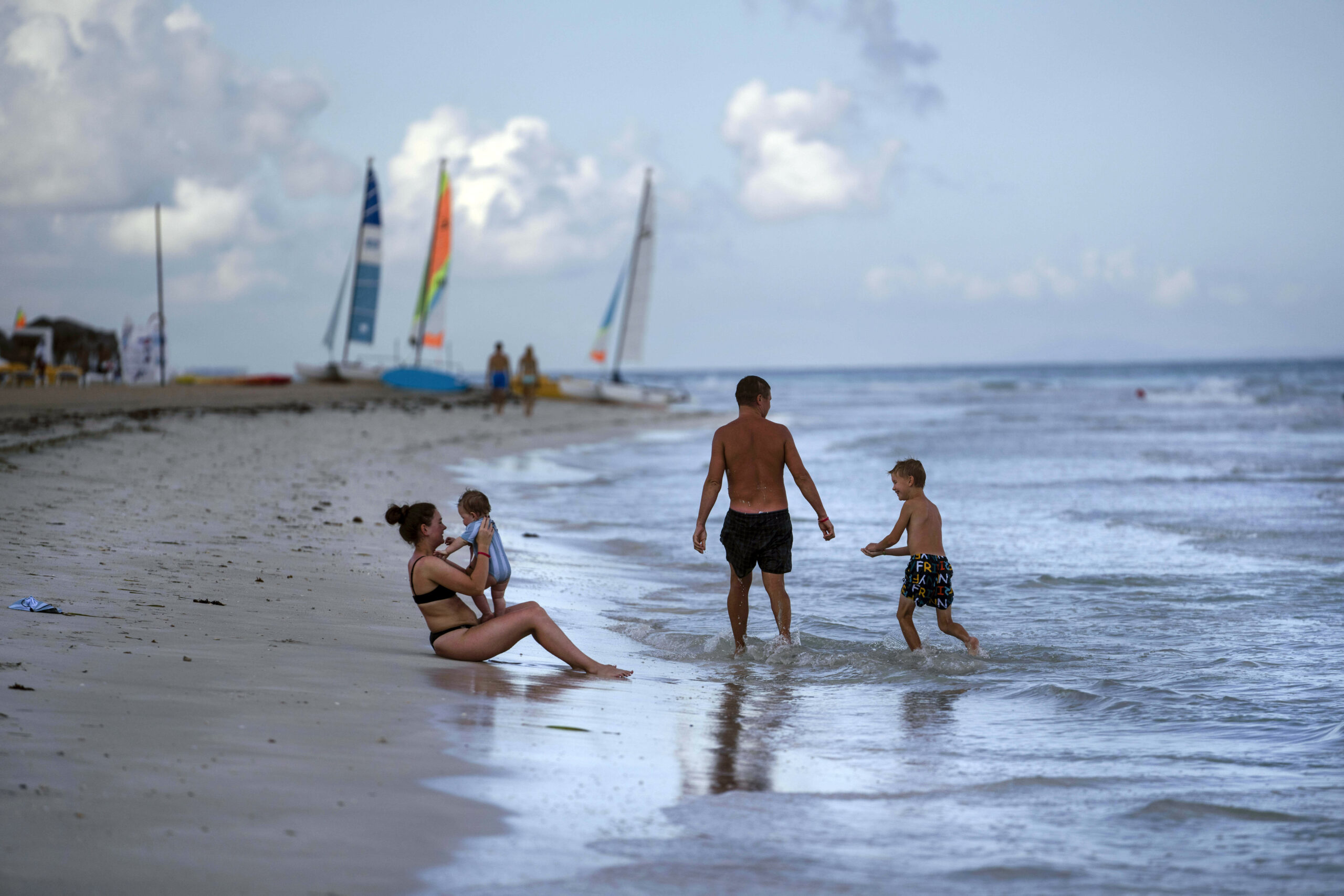 FILE - Tourists are seen along the beach at the Iberostar Selection Varadero hotel in Varadero, Cuba, on Sept. 29, 2021. The Biden administration announced Monday that it will expand flights to Cuba and lift Donald Trump-era restrictions on remittances that immigrants can send to people on the island. (AP Photo/Ramon Espinosa, File)