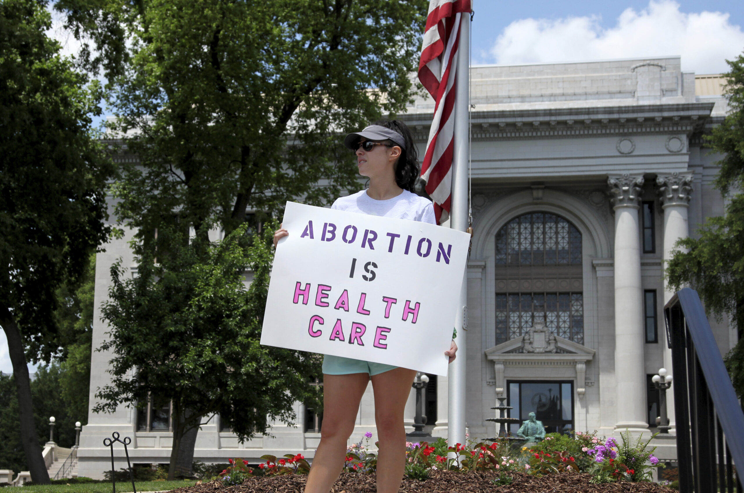 FILE - Abortion-rights demonstrator Jessica Smith holds a sign in front of the Hamilton County Court House on May 14, 2022, in Chattanooga, Tenn. A federal court on Tuesday, June 28, 2022, allowed Tennessee's ban on abortion as early as six weeks into pregnancy to take effect, citing the Supreme Court's decision last week to overturn the landmark Roe v. Wade abortion rights case. (AP Photo/Ben Margot, File)