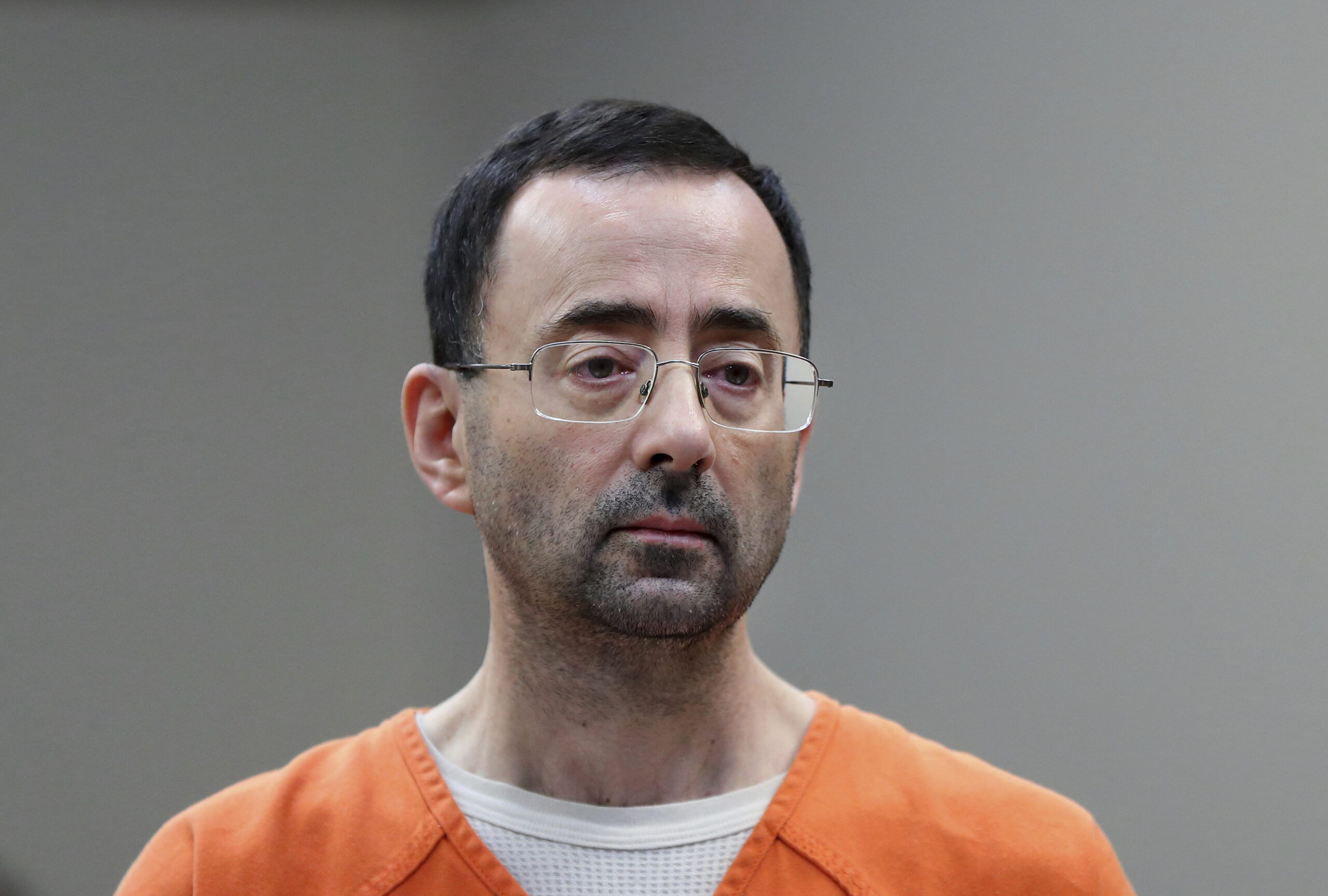 FILE - Dr. Larry Nassar, appears in court for a plea hearing on Nov. 22, 2017, in Lansing, Mich. The U.S. Justice Department said Thursday, May 26, 2022 it will not pursue criminal charges against former FBI agents who failed to quickly open an investigation of sports doctor Larry Nassar despite learning in 2015 that he was accused of sexually assaulting female gymnasts.(. (AP Photo/Paul Sancya File)