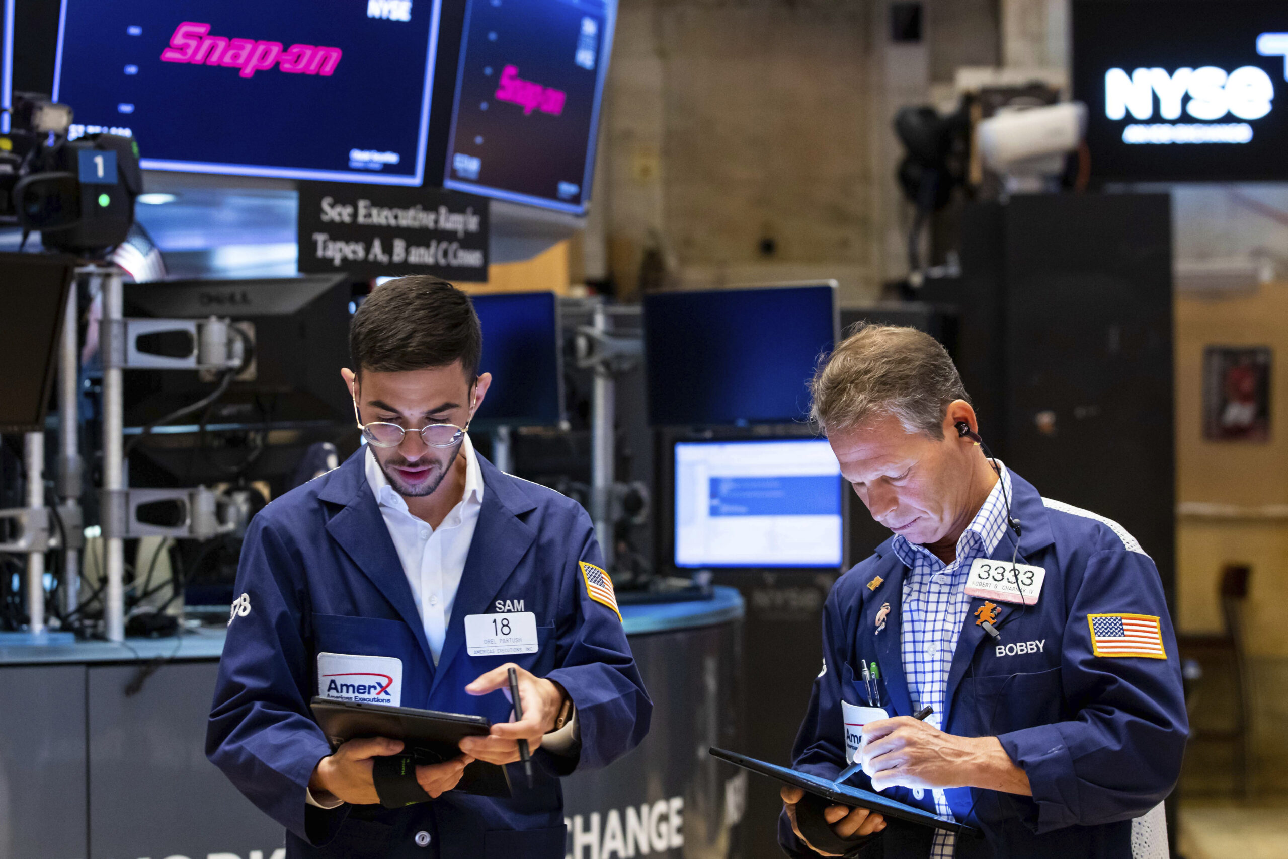 In this photo provided by the New York Stock Exchange, traders Orel Partush, left, and Robert Charmak work on the floor, Friday, June 10, 2022. Stocks on Wall Street fell sharply Friday after getting hammered by data showing inflation is getting worse, not better, as investors had been hoping. (David L. Nemec/New York Stock Exchange via AP)