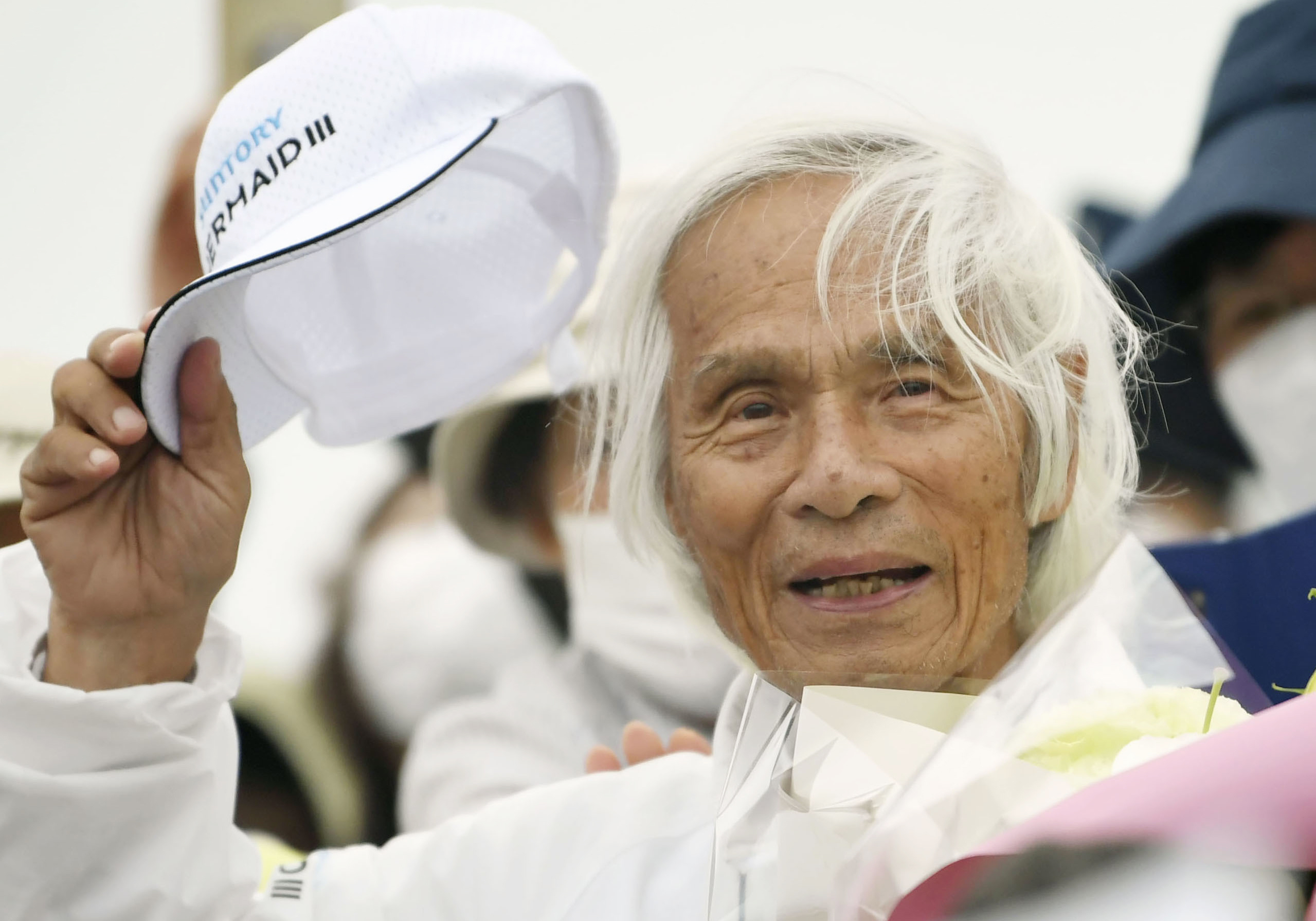 Japanese Kenichi Horie gets celebrated at a yacht harbor in Nishinomiya, western Japan, Sunday, June 5, 2022, after he completed his solo nonstop voyage across the Pacific Saturday. Horie’s return to Japan, after leaving San Francisco in March, made him the world’s oldest person to complete a solo, nonstop crossing of the Pacific, according to his sponsors. (Kosuke Moriwaki/Kyodo News via AP)