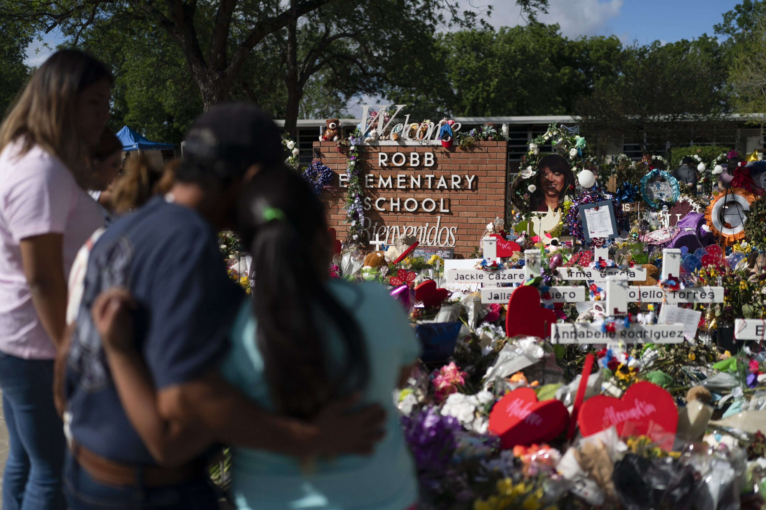 FILE - People visit a memorial at Robb Elementary School in Uvalde, Texas, on June 2, 2022, to pay their respects to the victims killed in a school shooting. A legislative committee investigating the deadly shooting at the Texas elementary school is set to hear more testimony from law enforcement officers on Monday, June 20, 2022. (AP Photo/Jae C. Hong, File)