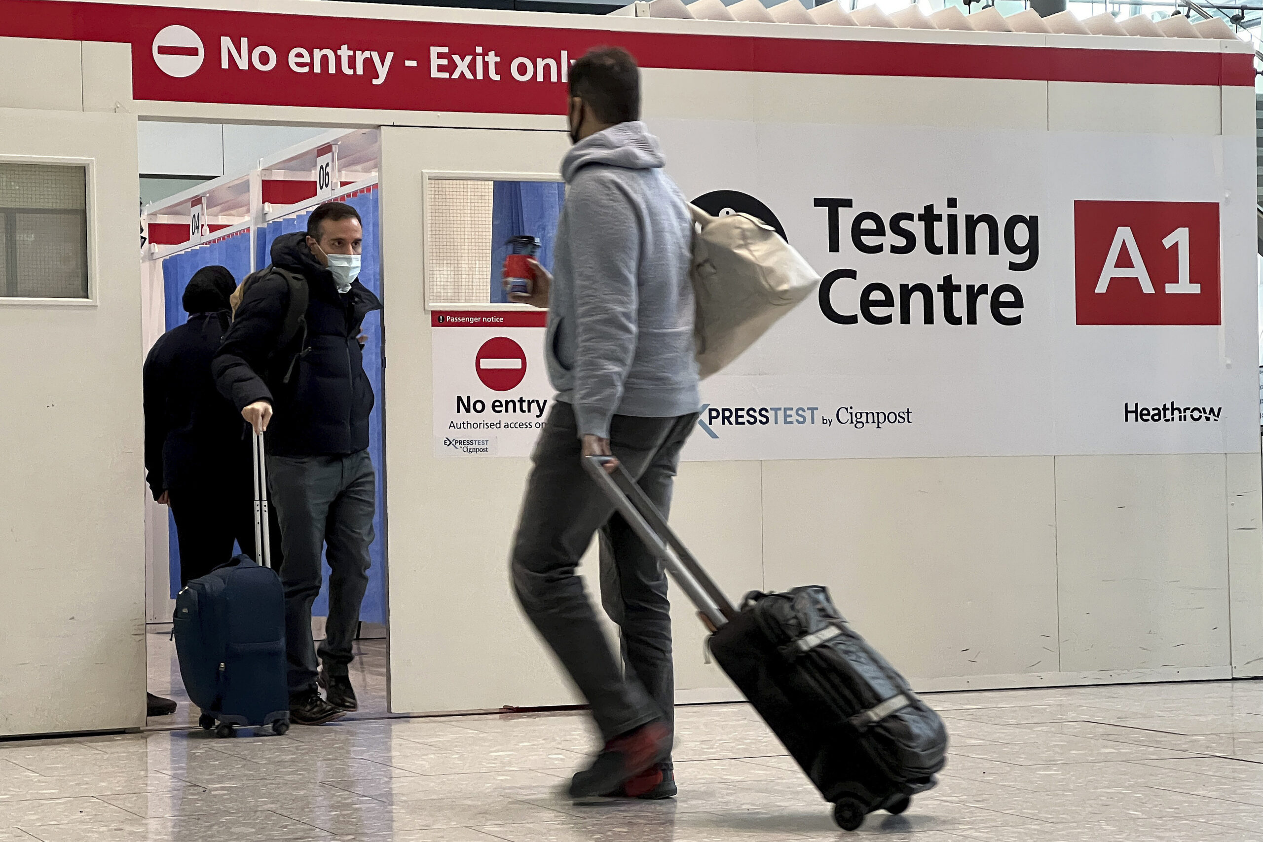 FILE - Passengers get a COVID-19 test at Heathrow Airport in London, Nov. 29, 2021. The Biden administration is lifting its requirement that international air travelers to the U.S. take a COVID-19 test within a day before boarding their flights, easing one of the last remaining government mandates meant to contain the spread of the coronavirus. A senior administration official says the mandate expires Sunday at 12:01 a.m. Eastern time. The official says the Centers for Disease Control and Prevention has determined that it’s no longer necessary. (AP Photo/Frank Augstein, File)