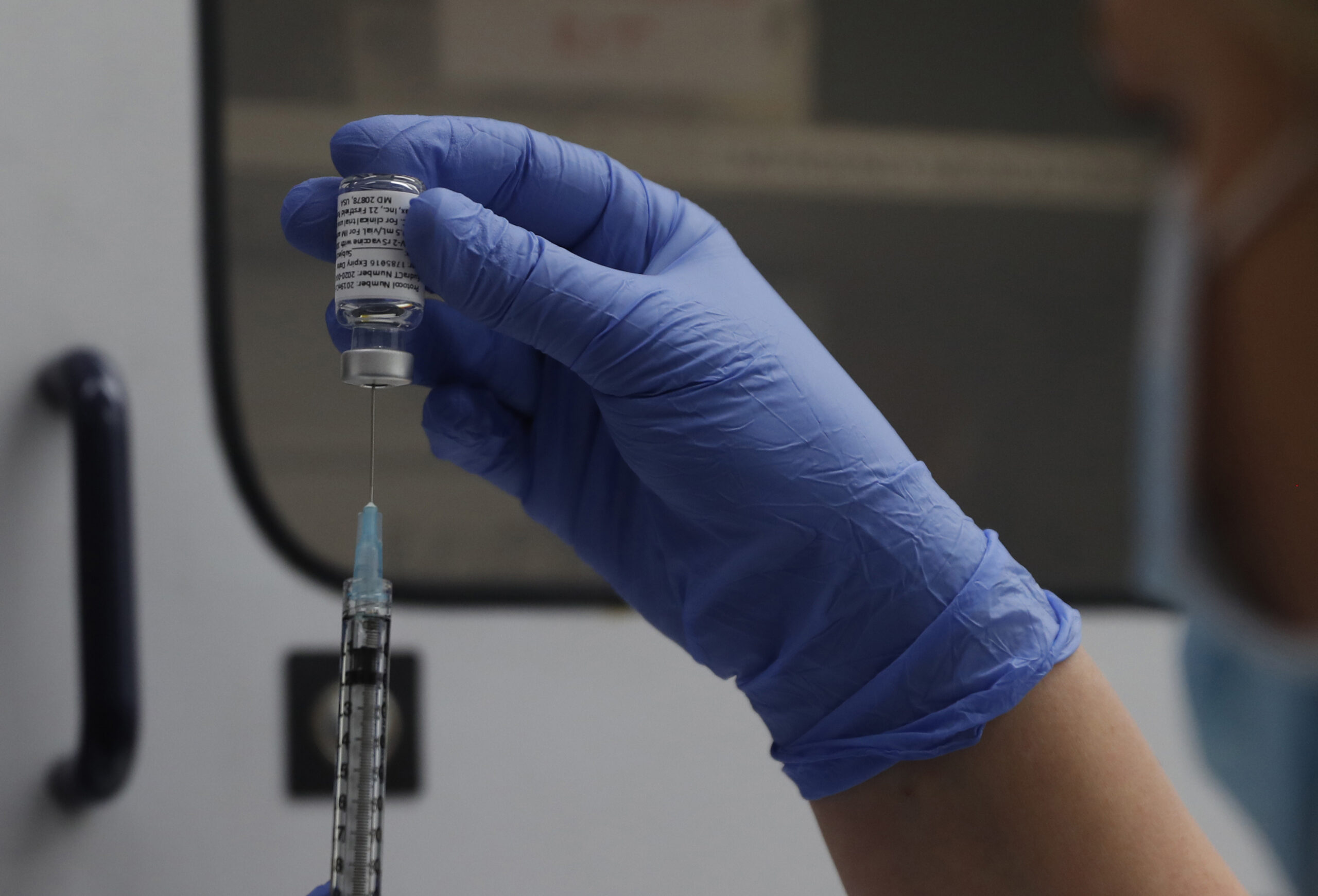 FILE - A vial of the Phase 3 Novavax coronavirus vaccine is seen ready for use in the trial at St. George's University hospital in London, Oct. 7, 2020. The Novavax COVID-19 vaccine that could soon win federal approval may offer a boost for the U.S. military: an opportunity to get shots into some of the thousands of service members who have refused the vaccine for religious reasons. (AP Photo/Alastair Grant, File)