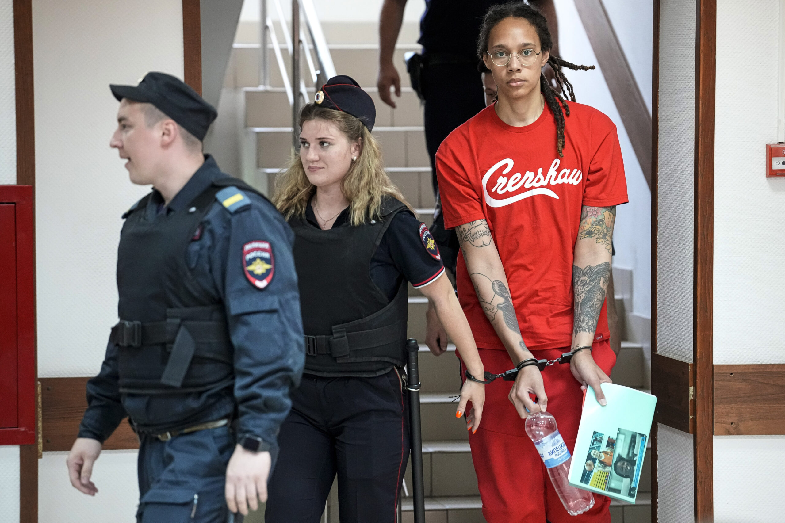 WNBA star and two-time Olympic gold medalist Brittney Griner is escorted to a courtroom for a hearing, in Khimki just outside Moscow, Russia, Thursday, July 7, 2022. Jailed American basketball star Brittney Griner returns to a Russian court on Thursday amid a growing chorus of calls for Washington to do more to secure her release nearly five months after being arrested on drug charges. (AP Photo/Alexander Zemlianichenko)