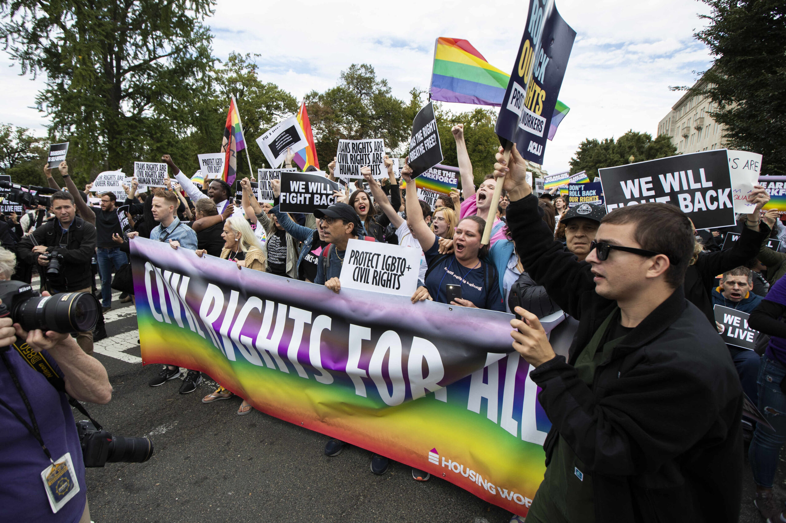 FILE - In this Oct. 8, 2019, photo, supporters of LGBTQ rights stage a protest on the street in front of the U.S. Supreme Court in Washington. A judge in Tennessee on Friday, July 15, 2022, has temporarily barred two federal agencies from enforcing directives issued by President Joe Biden's administration that extended protections for LGBTQ people in schools and workplaces. (AP Photo/Manuel Balce Ceneta, File)