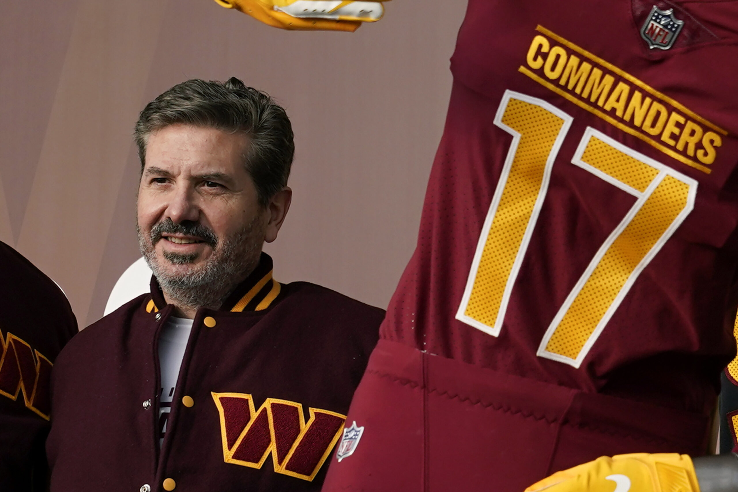 FILE - Washington Commanders' Dan Snyder poses for photos during an event to unveil the NFL football team's new identity, Wednesday, Feb. 2, 2022, in Landover, Md. Snyder is set to testify later Thursday morning, July 28, before a congressional committee that is investigating the NFL team’s history of workplace misconduct. (AP Photo/Patrick Semansky, File)