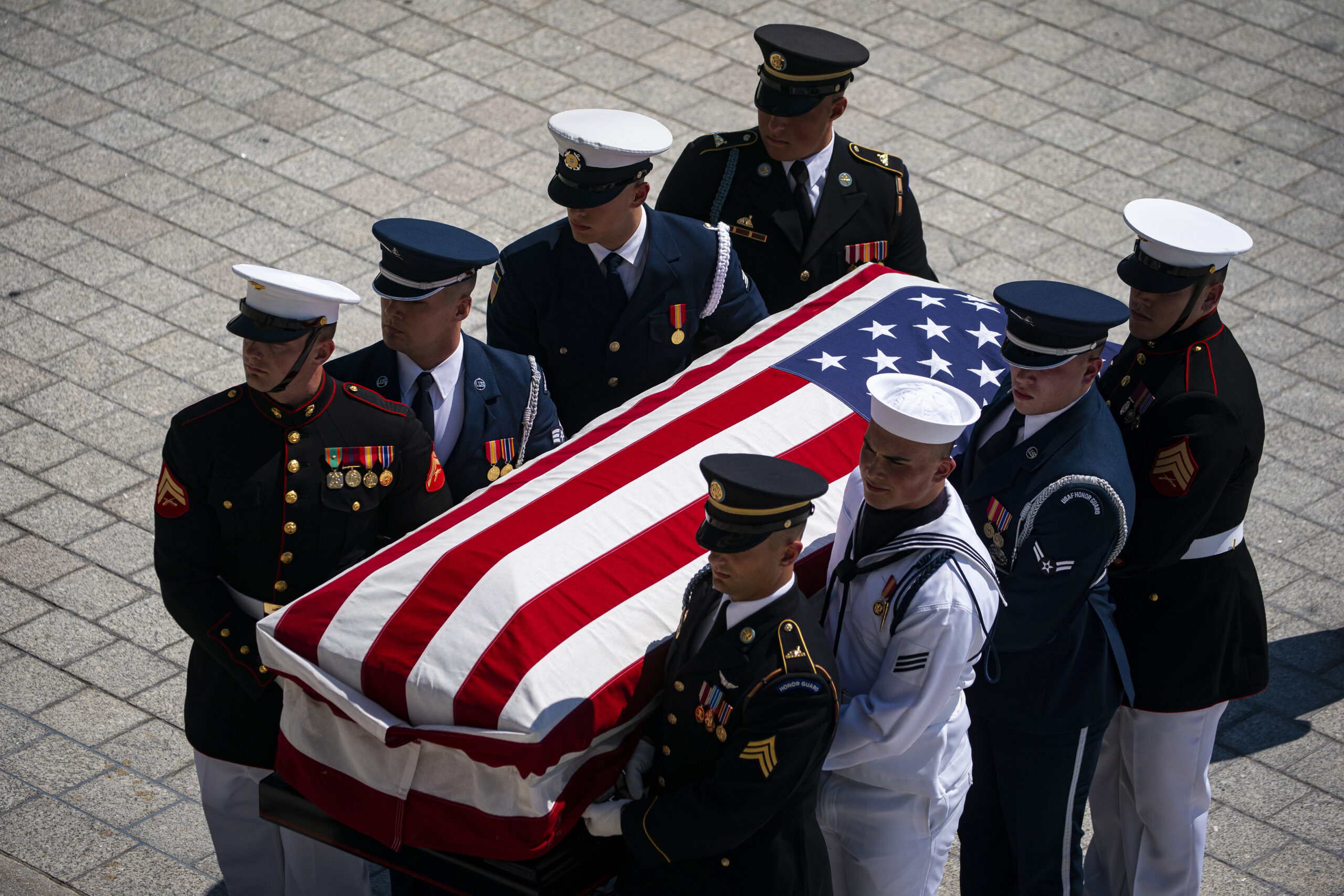 The flag-draped casket bearing the remains of Hershel W. “Woody” Williams is carried by joint service members into the U.S. Capitol, Thursday, July 14, 2022 in Washington, to lie in honor. Williams, the last remaining Medal of Honor recipient from World War II, died at age 98. (Al Drago/Pool Photo via AP)