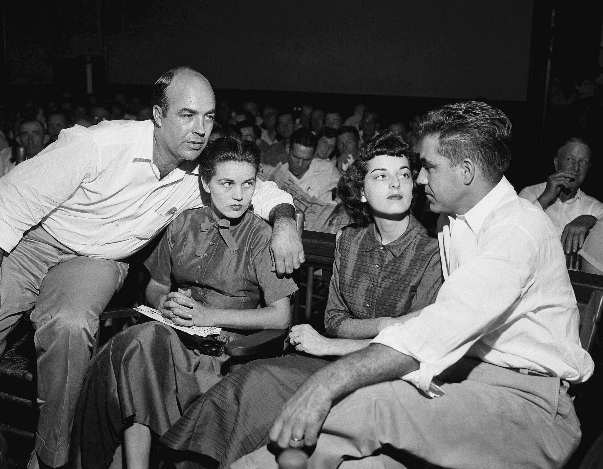 FILE - In this Sept. 23, 1955, file photo, J.W. Milam, left, his wife, second from left, Roy Bryant, far right, and his wife, Carolyn Bryant, sit together in a courtroom in Sumner, Miss. Bryant and his half-brother Milam were charged with murder but acquitted in the kidnapping and torture slaying of 14-year-old black teen Emmett Till in 1955 after he allegedly whistled at Carolyn Bryant. A team searching the basement of a Mississippi courthouse for evidence about the lynching of Black teenager Emmett Till has found the unserved warrant in June 2022 charging a white woman in his kidnapping in 1955, and relatives of the victim want authorities to finally arrest her nearly 70 years later. (AP Photo, File)