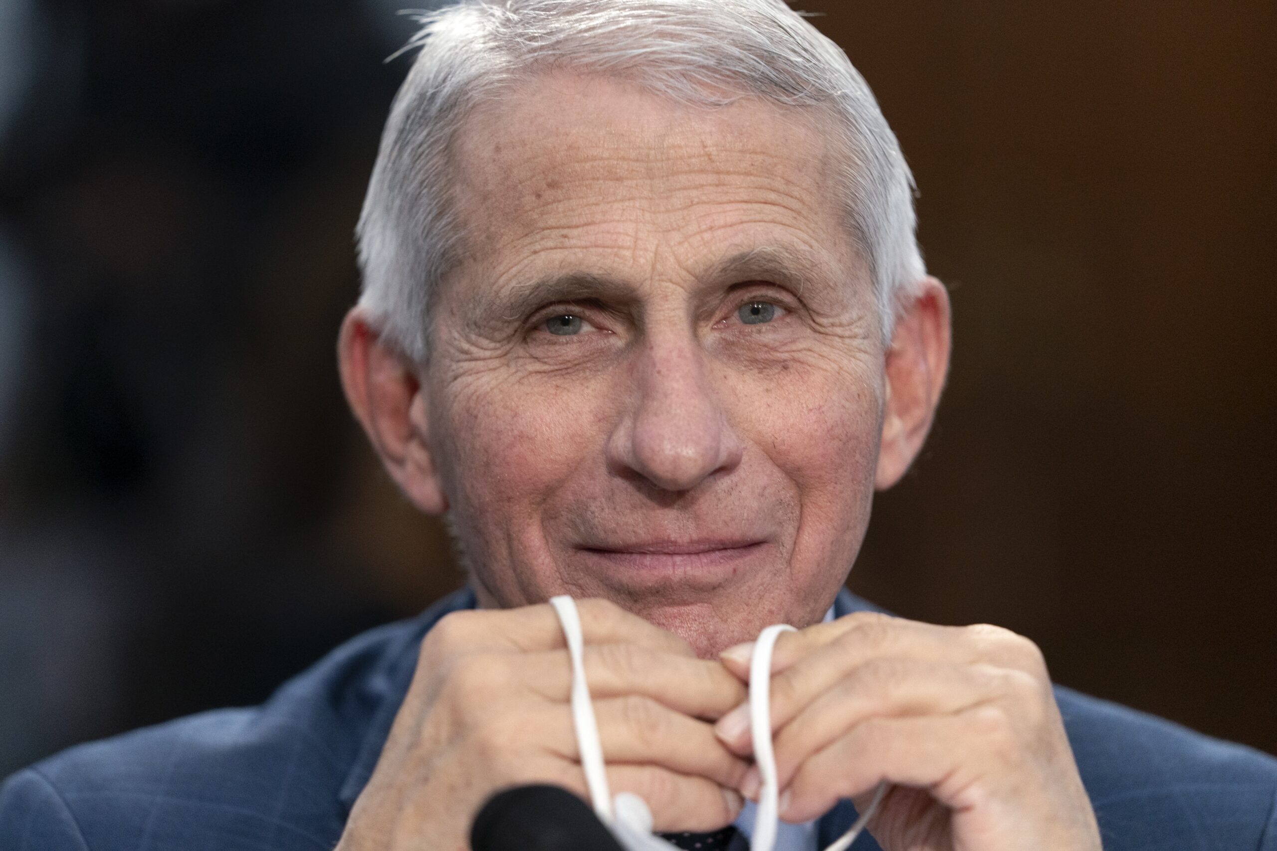 FILE - Dr. Anthony Fauci, Director of the National Institute of Allergy and Infectious Diseases, holds his face mask in his hands as he attends a House Committee on Appropriations subcommittee hearing on about the budget request for the National Institutes of Health, May 11, 2022, on Capitol Hill in Washington. Fauci, the government’s top infectious disease expert, says he plans to retire by the end of President Joe Biden’s term in January 2025. Fauci, 81, became director of the National Institute of Allergy and Infectious Diseases in 1984 and has advised seven presidents. (AP Photo/Jacquelyn Martin, File)