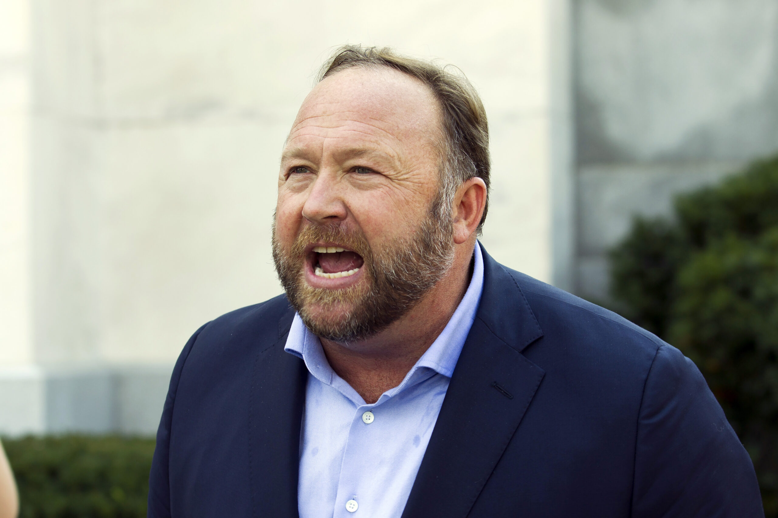FILE - Infowars host and conspiracy theorist Alex Jones speaks outside of the Dirksen building on Capitol Hill in Washington, Sept. 5, 2018. Jury selection is set for Monday, July 25, 2022, in a trial that will determine for the first time how much Jones must pay Sandy Hook Elementary School parents for falsely telling his audience that the deadliest classroom shooting in U.S. history was a hoax. (AP Photo/Jose Luis Magana, File)