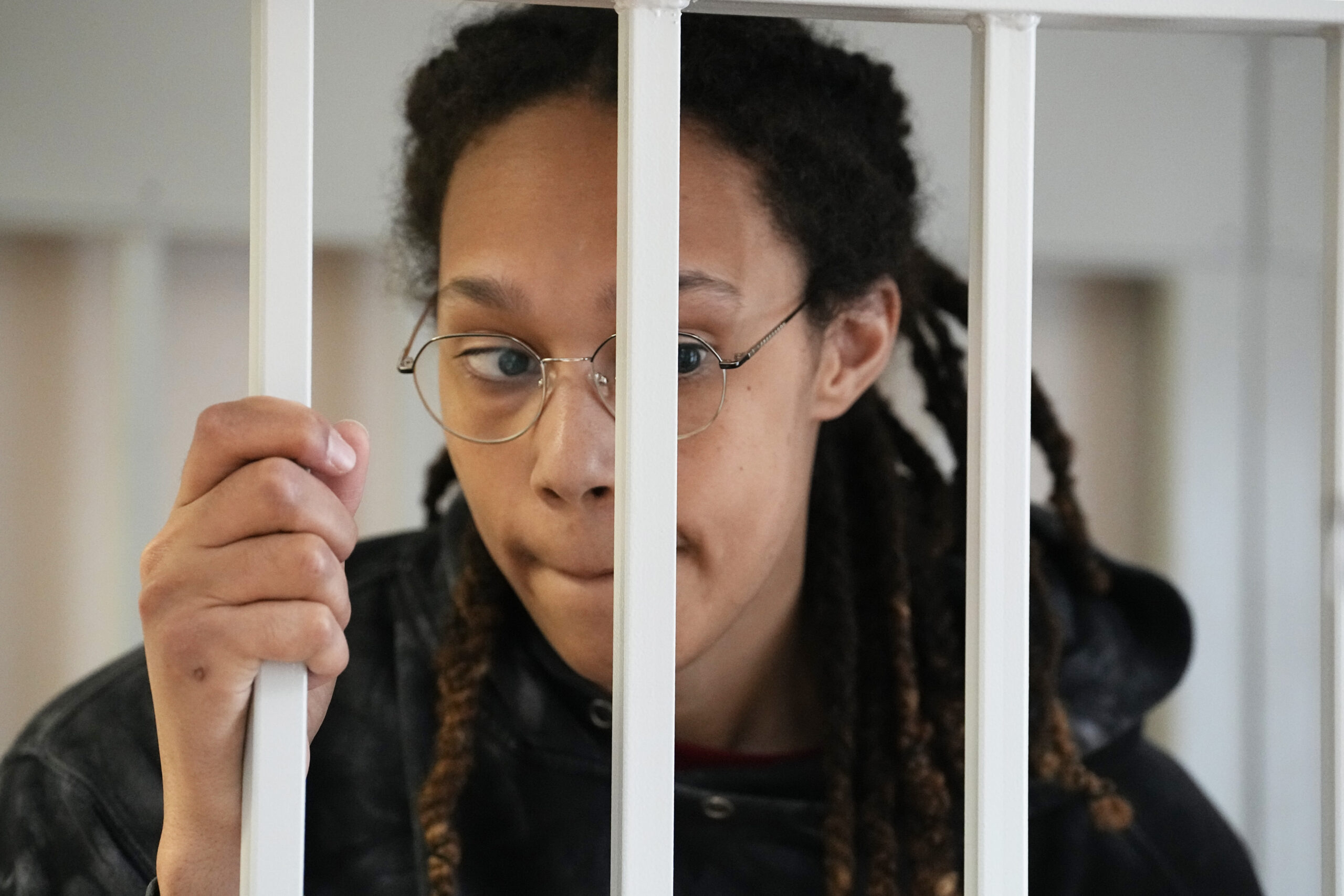 WNBA star and two-time Olympic gold medalist Brittney Griner stands in a cage at a court room prior to a hearing, in Khimki just outside Moscow, Russia, Tuesday, July 26, 2022. American basketball star Brittney Griner has returned to a Russian courtroom for her drawn-out trial on drug charges that could bring her 10 years in prison if convicted. (AP Photo/Alexander Zemlianichenko, Pool)