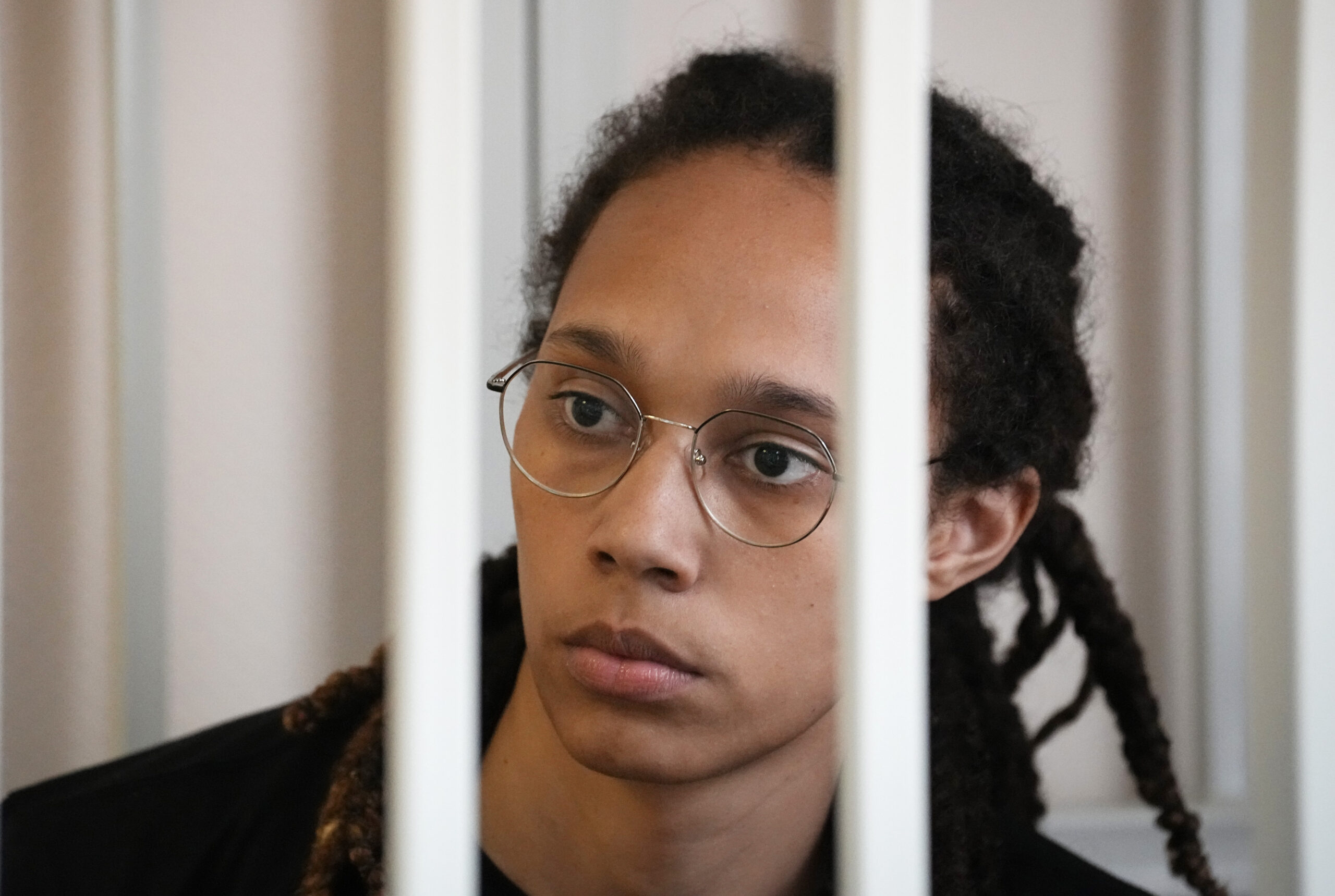 WNBA star and two-time Olympic gold medalist Brittney Griner sits in a cage at a court room prior to a hearing, in Khimki just outside Moscow, Russia, Wednesday, July 27, 2022. American basketball star Brittney Griner returned Wednesday to a Russian courtroom for her drawn-out trial on drug charges that could bring her 10 years in prison of convicted. (AP Photo/Alexander Zemlianichenko, Pool)
