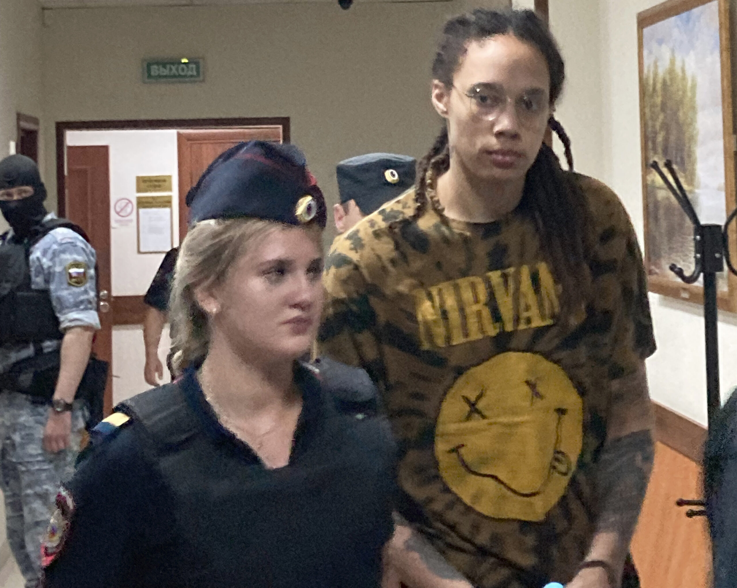 WNBA star and two-time Olympic gold medalist Brittney Griner is escorted to a courtroom for a hearing in the Khimki district court, just outside Moscow, Russia, Friday, July 15, 2022. Griner was arrested in February at the Russian capital's Sheremetyevo Airport when customs officials said they found vape canisters with cannabis oil in her luggage. She has been jailed since then, facing up to 10 years in prison if convicted. (AP Photo/Jim Heintz)