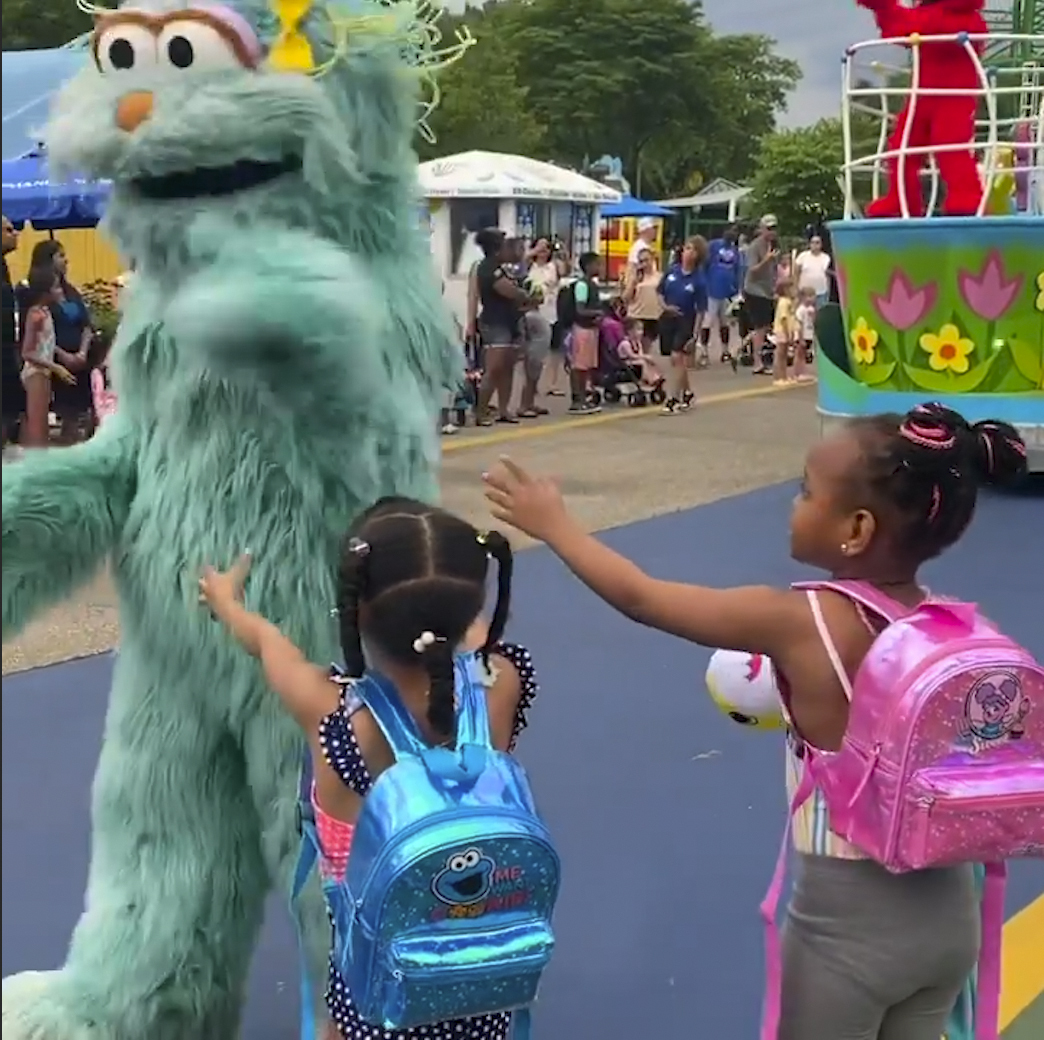 In this image from video provided by Jodi Brown, posted to Instagram on Saturday, July 16, 2022, a performer dressed as the character Rosita waves off Brown's daughter and another 6-year-old Black girl at the Sesame Place amusement park in Langhorne, Pa. (Jodi Brown via AP)