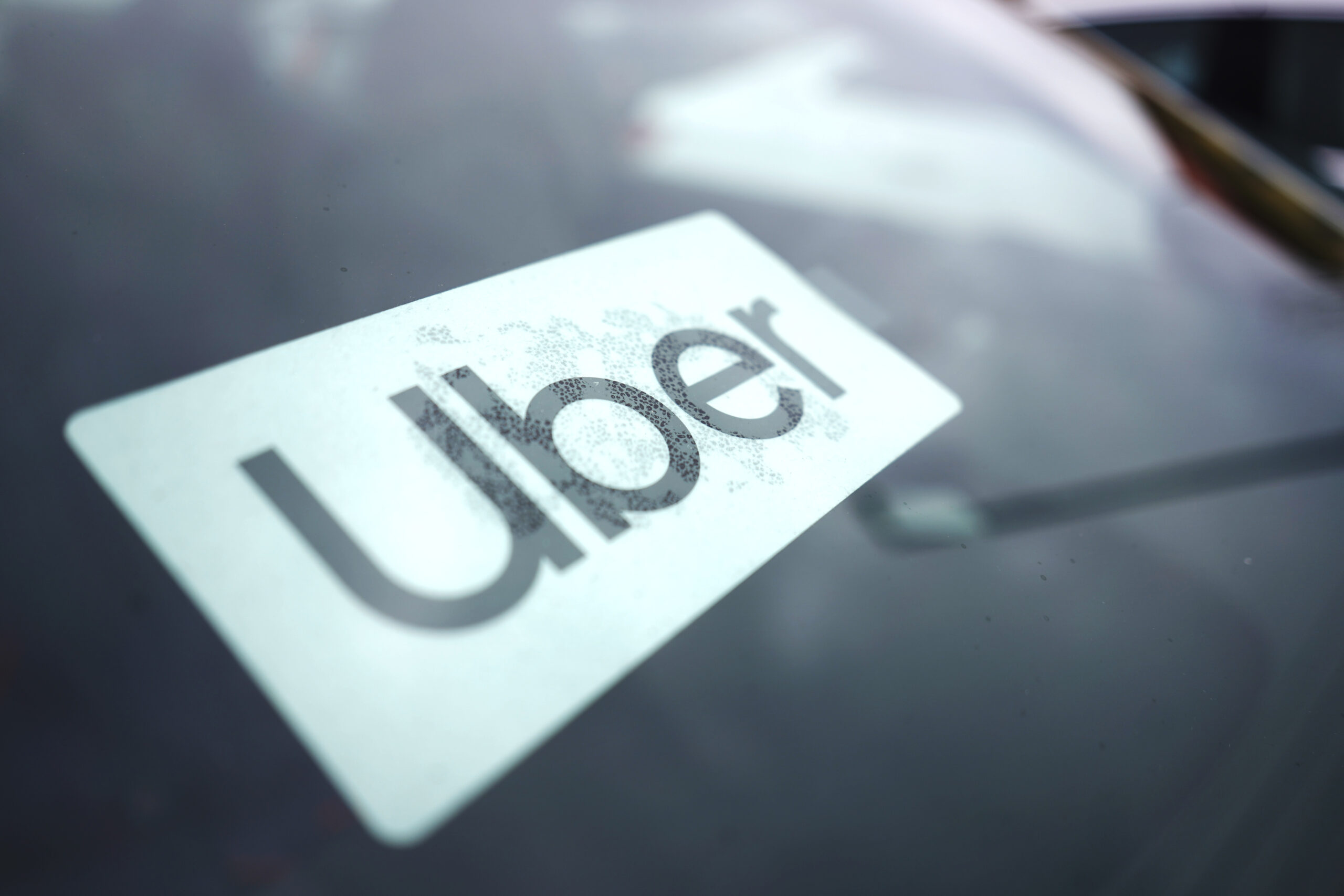 An Uber sign is displayed inside a car in Palatine, Ill., Thursday, Feb. 10, 2022. As Uber pushed into markets around the world, the ride-sharing service lobbied political leaders to relax labor and taxi laws and used a “kill switch″ to thwart regulators and law enforcement. Uber also channeled money through Bermuda and other tax havens and considered portraying violence against its drivers as a way to gain public sympathy. That's according to a report released Sunday by the International Consortium of Investigative Journalists. (AP Photo/Nam Y. Huh)