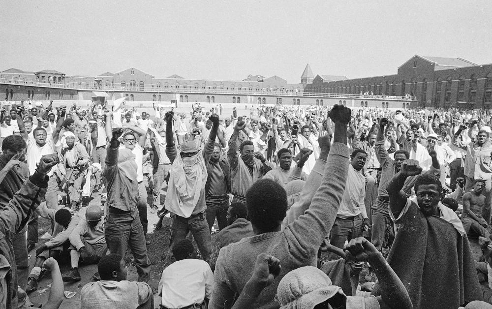 Inmates at Attica State Prison in Attica, N.Y., raise their hands in clenched fists in a show of unity, Sept. 1971, during the Attica uprising, which took the lives of 43 people.