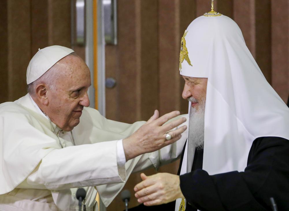 Pope Francis, left, reaches to embrace Russian Orthodox Patriarch Kirill after signing a joint declaration at the Jose Marti International airport in Havana, Cuba o Feb. 12, 2016.