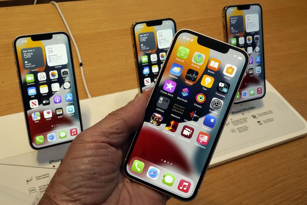 FILE - The line-up of the Apple iPhone 13 is displayed on their first day of sale, in New York, Friday, Sept. 24, 2021, iPhone 13 mini, foregroud, iPhone 13, iPhone 13 Pro, and iPhone 13 ProMax, left to right, background. Apple's latest security update was easy to miss. But security experts are warning that everyone should update any Apple device they have immediately. Apple said Wednesday, Aug. 17, 2022, that there are serious security vulnerabilities for iPhones, iPads and Macs that could potentially allow attackers to take complete control of these devices, and that the issue may already have been "actively exploited." (AP Photo/Richard Drew, File)