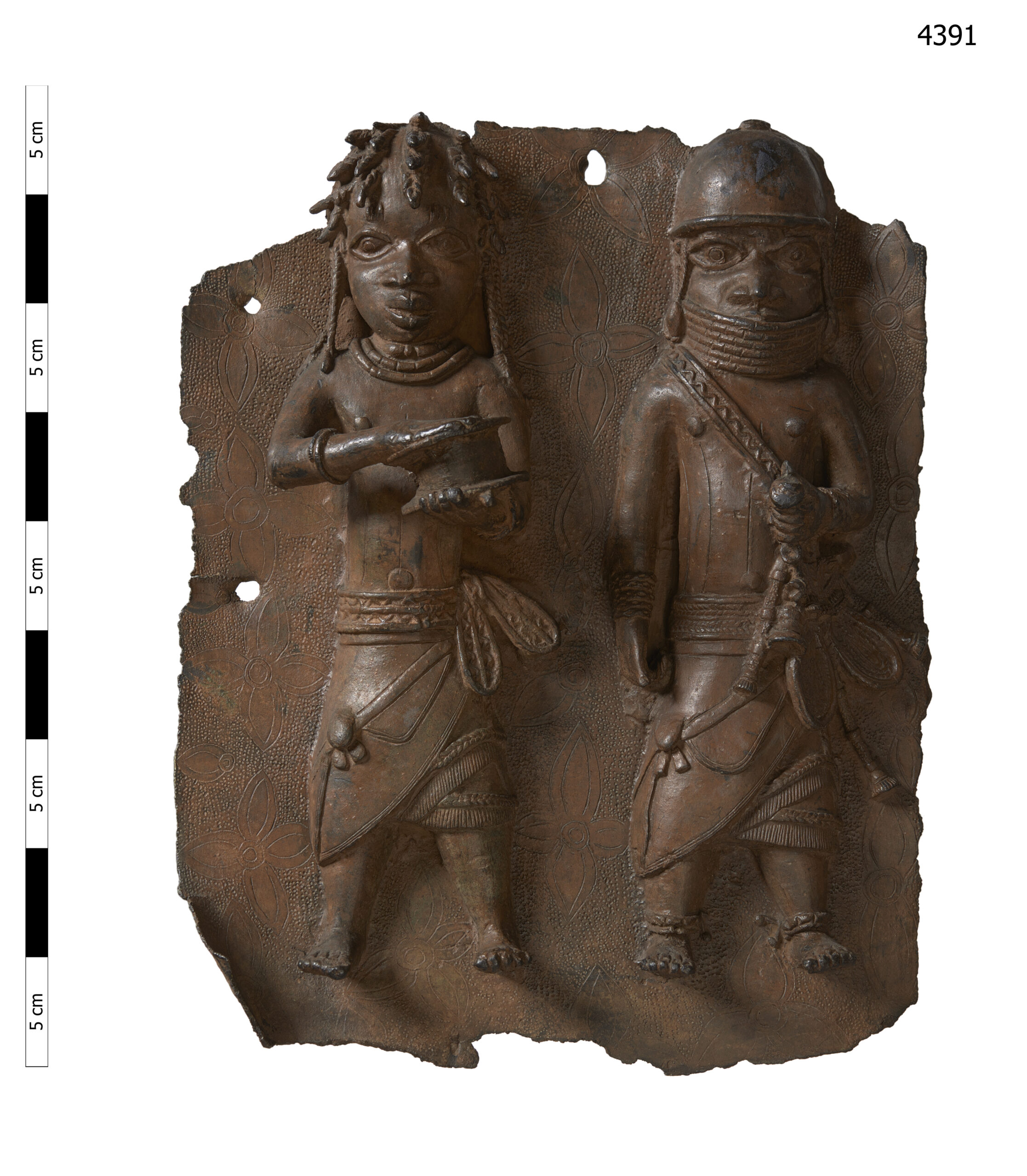 This handout photo provided by Horniman Museum and Gardens shows a brass plaque depicting a war chief and a royal military priest carrying a leather gift box. London's Horniman Museum and Gardens announced Sunday, Aug. 7, 2022 that it had agreed to return a collection of Benin Bronzes looted in the late 19th century from what is now Nigeria. (Horniman Museum and Gardens via AP)