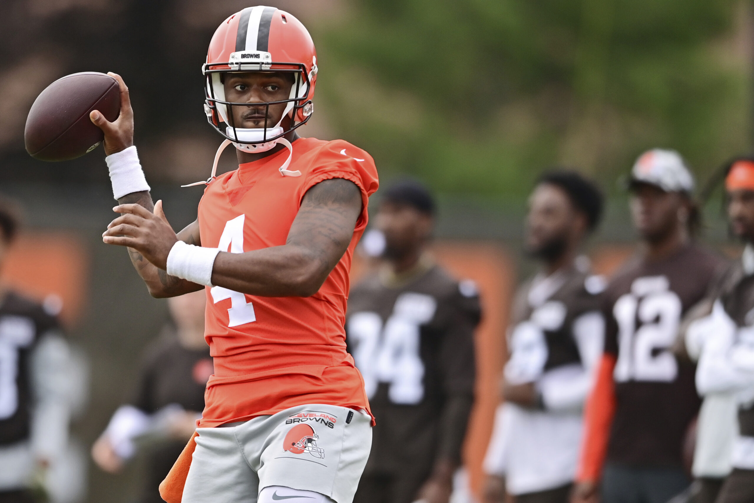 FILE - Cleveland Browns quarterback Deshaun Watson throws during NFL football practice in Berea, Ohio, Sunday, Aug. 14, 2022. A person familiar with the situation tells The Associated Press on Thursday, Aug. 18, 2022, that Watson has reached a settlement with the NFL and will serve an 11-game suspension and pay a $5 million fine rather than risk missing his first season as quarterback of the Browns following accusations of sexual misconduct while he played for the Houston Texans. (AP Photo/David Dermer, File)