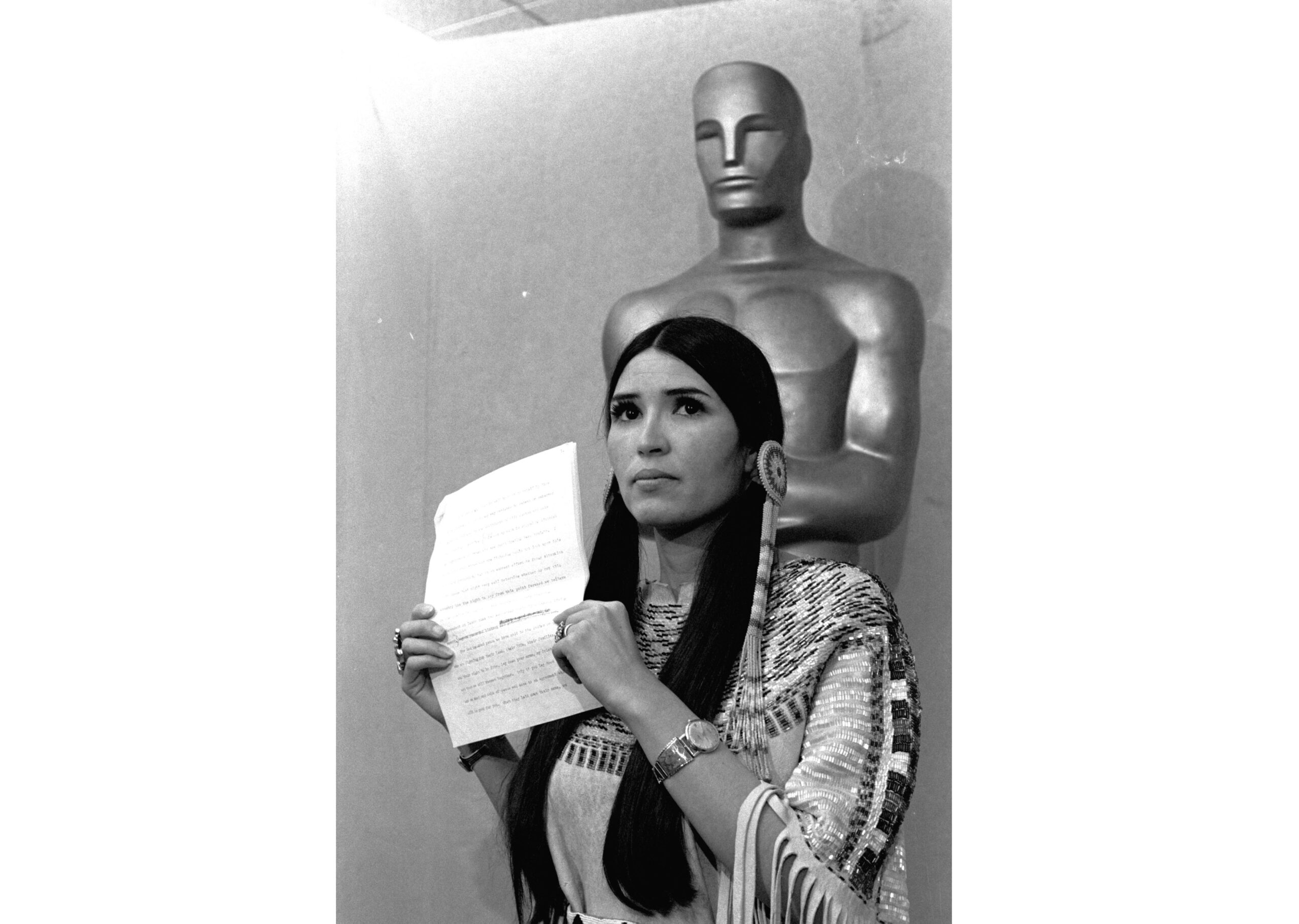 FILE - Sacheen Littlefeather appears at the Academy Awards ceremony to announce that Marlon Brando was declining his Oscar as best actor for his role in "The Godfather," on March 27, 1973. The move was meant to protest Hollywood's treatment of American Indians. Nearly 50 years later, the Academy of Motion Pictures Arts and Sciences has apologized to Littlefeather for the abuse she endured. The Academy Museum of Motion Pictures on Monday said that it will host Littlefeather, now 75, for an evening of “conversation, healing and celebration” on Sept. 17. (AP Photo, File)