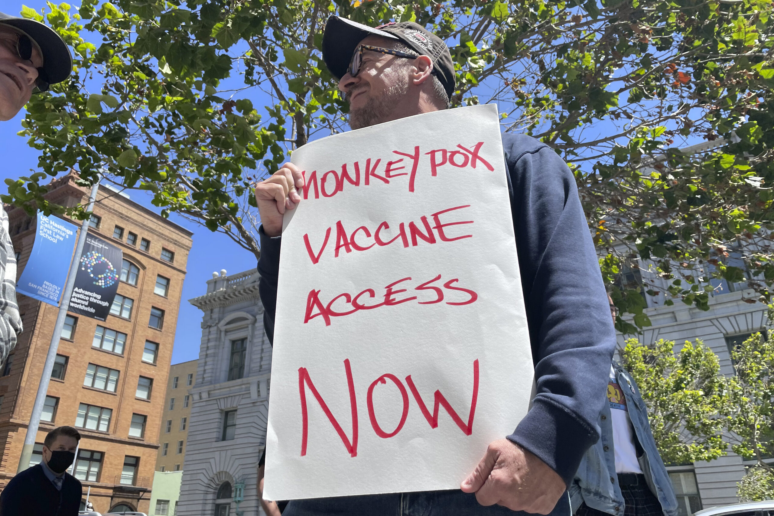 FILE - A man holds a sign urging increased access to the monkeypox vaccine during a protest in San Francisco, July 18, 2022. California's governor on Monday, Aug. 1, 2022, declared a state of emergency to speed efforts to combat the monkeypox outbreak, becoming the second state in three days to take the step. (AP Photo/Haven Daley, File)