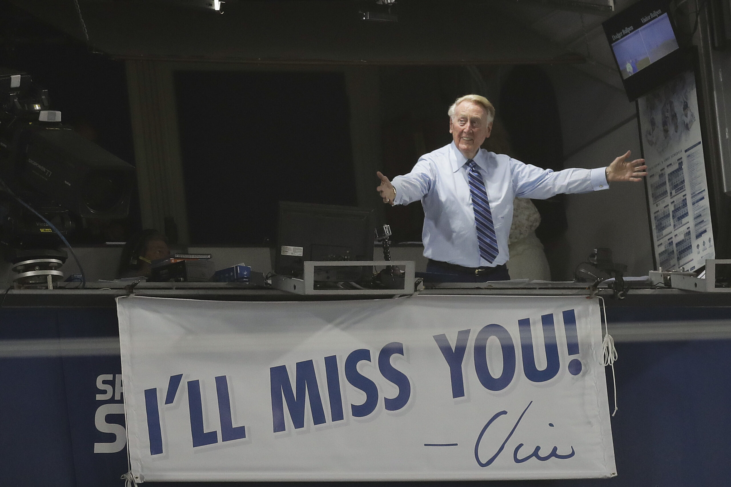 FILE - Los Angeles Dodgers broadcaster Vin Scully gestures in his booth during a baseball game between the Los Angeles Dodgers and the Colorado Rockies, Sept. 23, 2016, in Los Angeles, two days before his final game from Dodger Stadium. Scully, whose dulcet tones provided the soundtrack of summer while entertaining and informing Dodgers fans in Brooklyn and Los Angeles for 67 years, died Tuesday night, Aug. 2, 2022, the team said. He was 94. (AP Photo/Jae C. Hong, File)