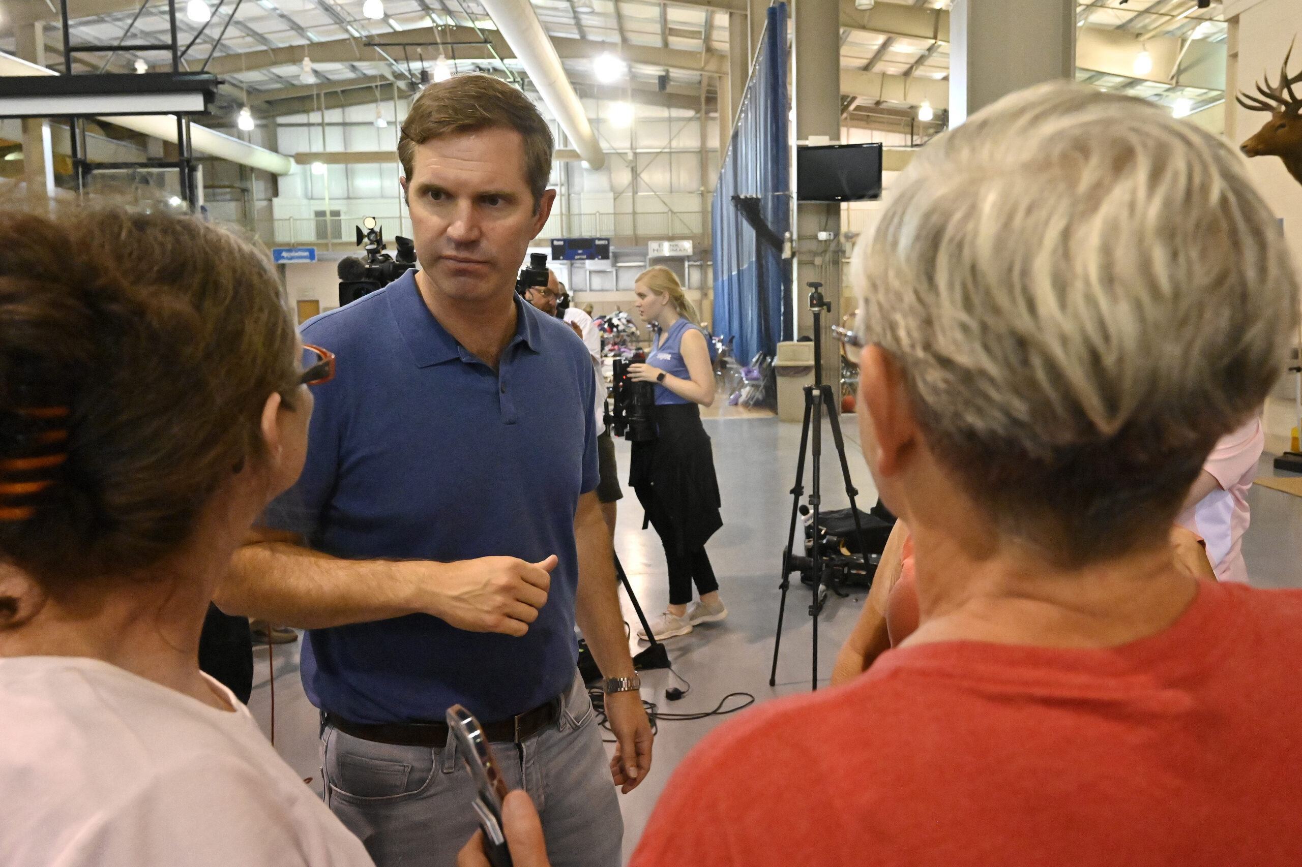 Kentucky Governor Andy Beshear, center, answers question from residents of Knott County Ky., that have been displaced by floodwaters at the Knott County Sportsplex in Leburn, Ky., Sunday, July 31, 2022. (AP Photo/Timothy D. Easley)