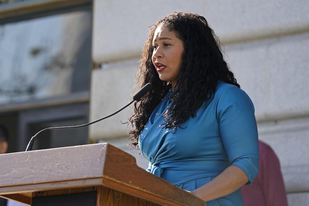 FILE - San Francisco Mayor London Breed speaks during a briefing outside City Hall in San Francisco on Dec. 1, 2021. Supervisors in San Francisco voted Tuesday, Sept. 20, 2022, for a trial run allowing police to monitor in real time private surveillance cameras in certain circumstances, despite strong objections from civil liberties groups alarmed by the potential impact to privacy. The ability to monitor in real time was requested by Breed and supported by merchants and residents who say police officers need more tools to combat drug dealing and retail theft. (AP Photo/Eric Risberg, File)