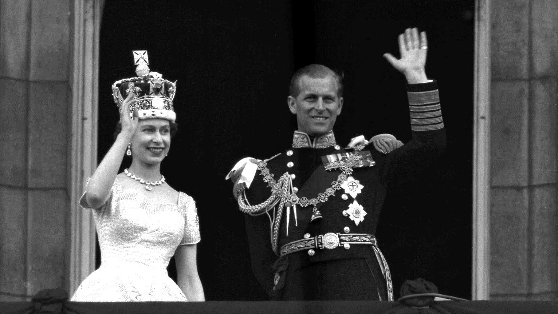 FILE - In this June. 2, 1953 file photo, Britain's Queen Elizabeth II and Prince Philip, Duke of Edinburgh wave to supporters from the balcony at Buckingham Palace, following her coronation at Westminster Abbey, London. Queen Elizabeth II, Britain’s longest-reigning monarch and a rock of stability across much of a turbulent century, has died. She was 96. Buckingham Palace made the announcement in a statement on Thursday Sept. 8, 2022. (AP Photo/Leslie Priest, File)