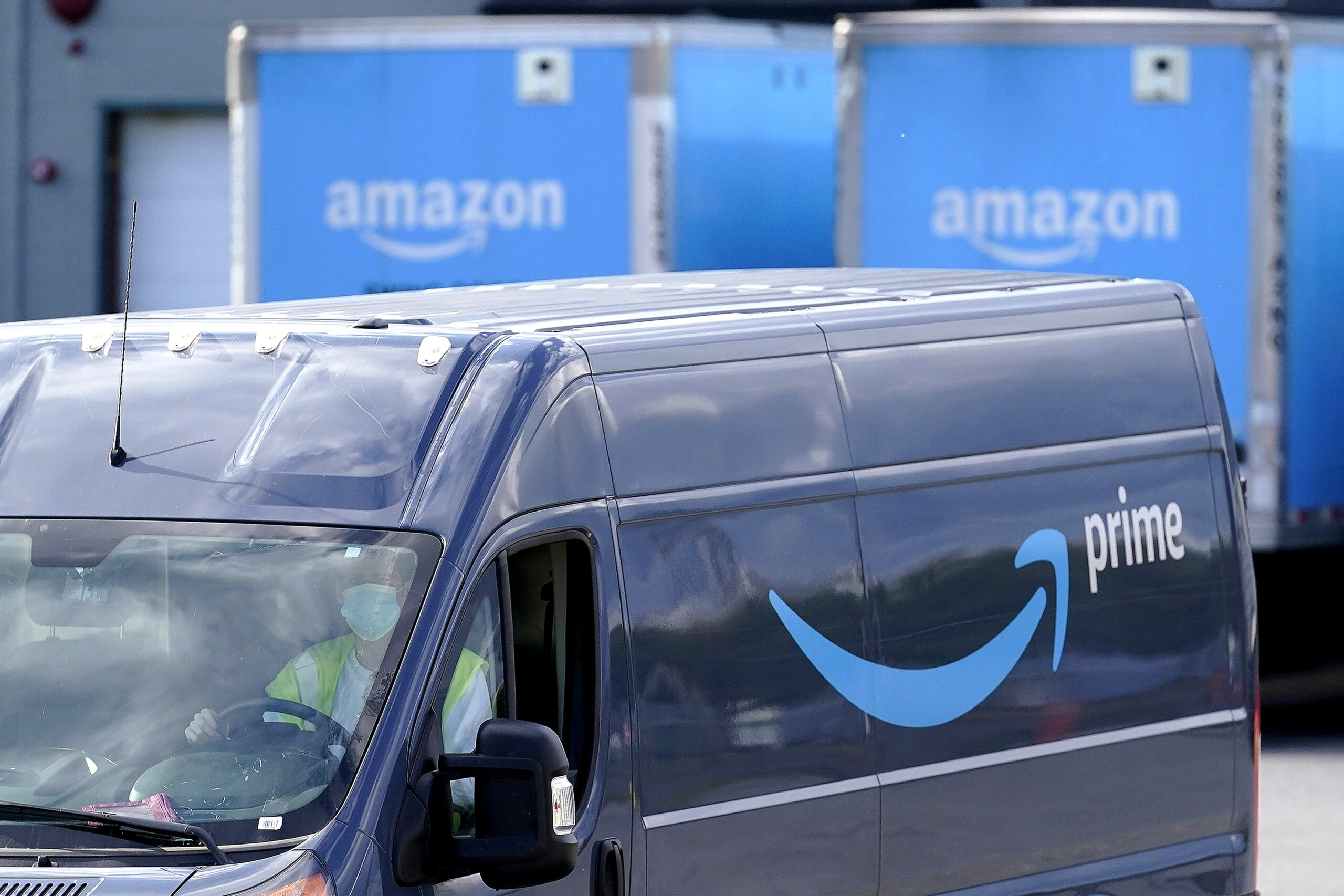 FILE - An Amazon Prime logo appears on the side of a delivery van as it departs an Amazon Warehouse location in Dedham, Mass., Oct. 1, 2020. Amazon is holding a second Prime Day-like shopping event in October 2022, making it the latest major retailer to offer holiday deals earlier to entice cautious consumers struggling with tighter budgets. (AP Photo/Steven Senne, File)