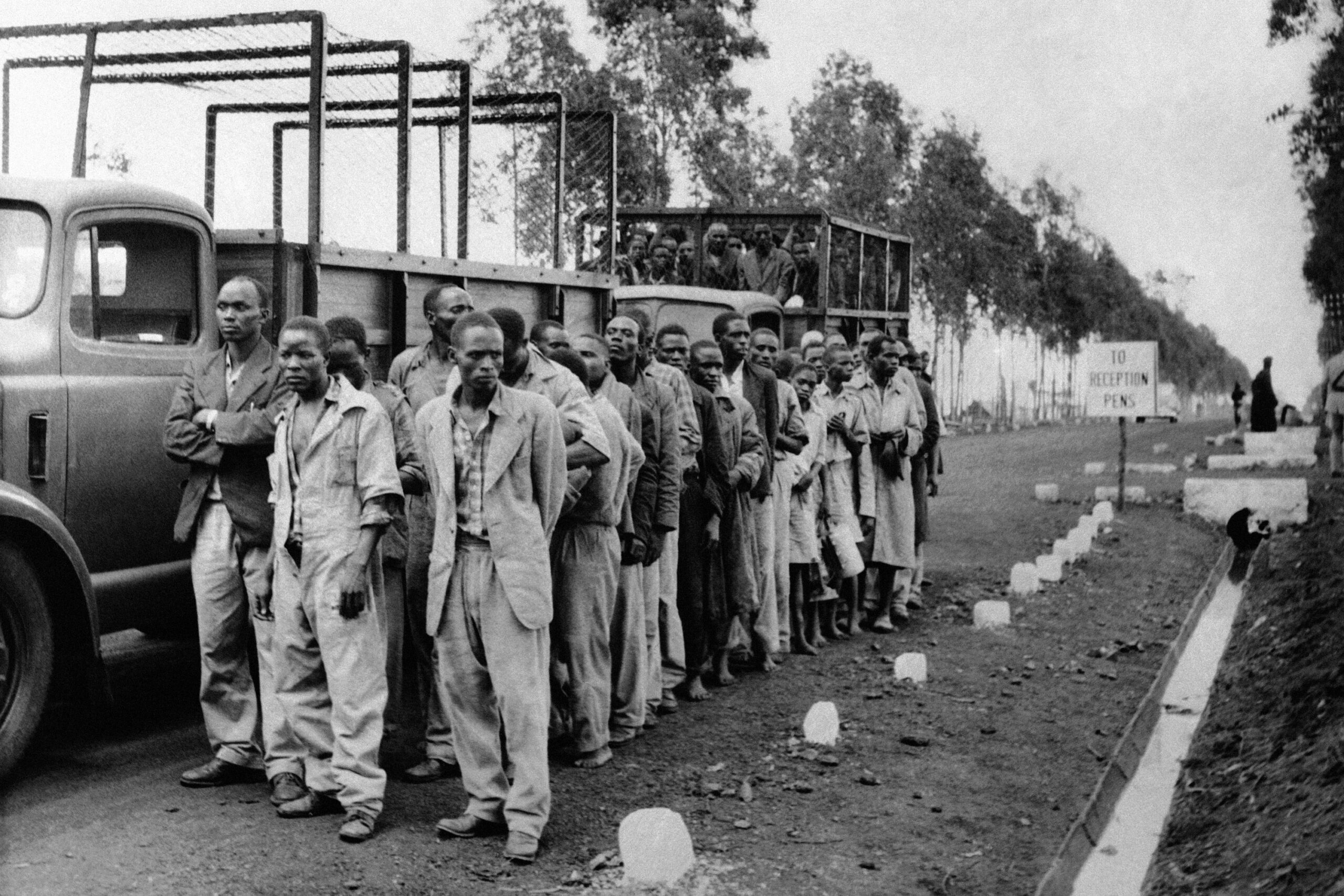 Two lorry loads transporting Kikuyu people arrive at a reception camp outside Nairobi, Kenya, on April 28, 1954, after 5,000 British troops and 1,000 armed police rounded up some 30,000 to 40,000 men for screening. The sweep followed the breakdown of the surrender invitation launched by the authorities after the capture of Mau Mau's "General China." At the reception camp many men were released after screening. Others were sent to detention camps by the sea. (AP Photo, File)
