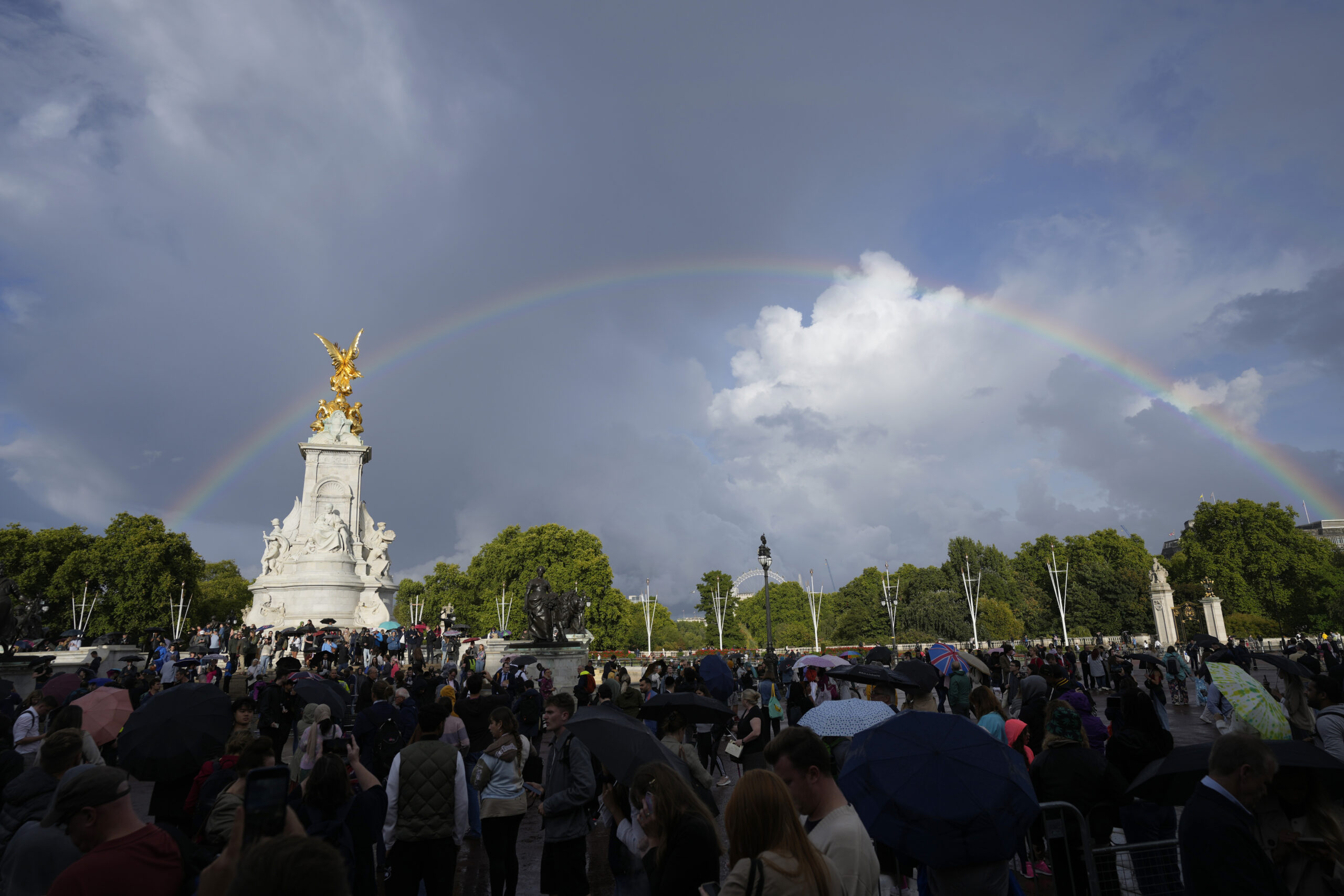 People gather outside Buckingham Palace in London, Thursday, Sept. 8, 2022. Buckingham Palace says Queen Elizabeth II has been placed under medical supervision because doctors are 